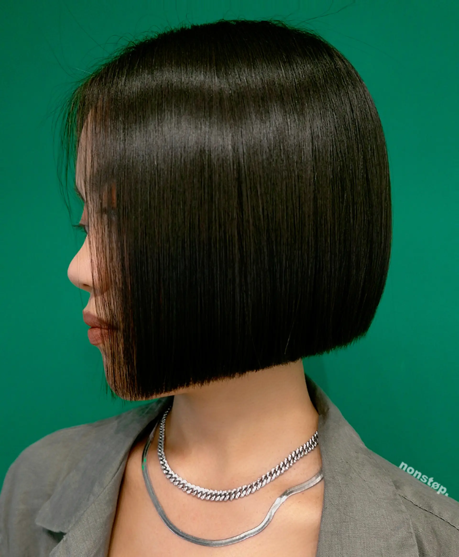 This sleek, straight bob is a polished and modern style featuring blunt ends and an angular cut that beautifully frames the face. The hair is perfectly straight, short in length, and showcases a rich black color, giving it an edgy yet sophisticated look. The hair falls effortlessly, highlighting the minimalist yet chic nature of the cut. 2