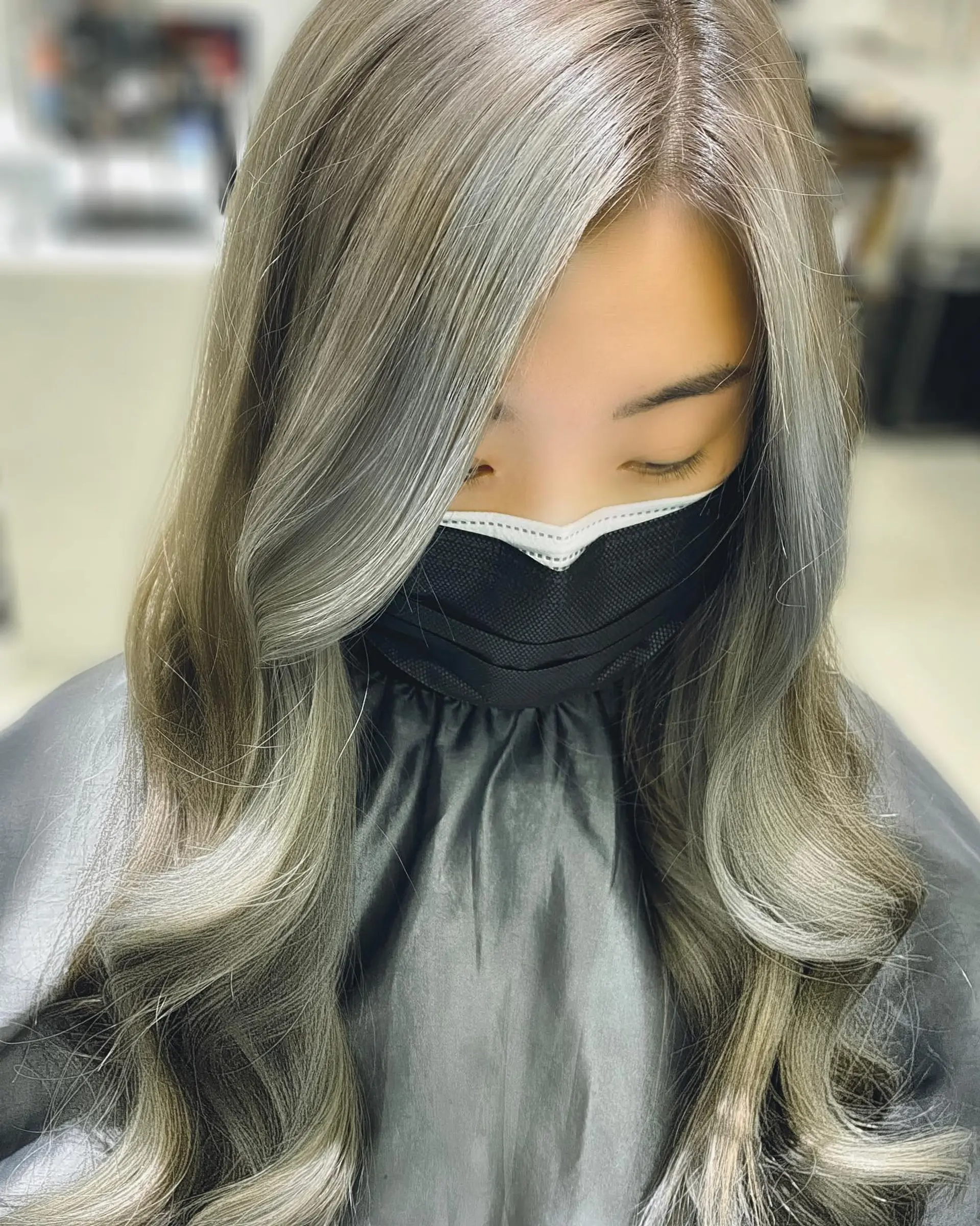 A long, wavy hairstyle with ash blonde balayage. 1