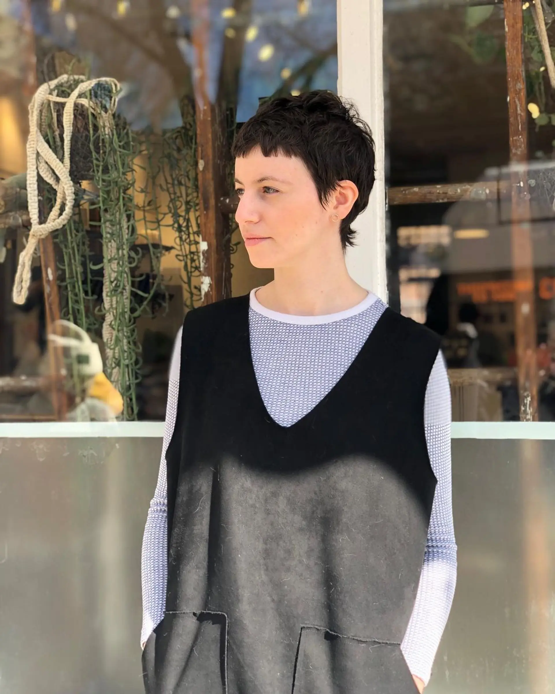 Short, dark brown pixie cut with short layers, textured ends, and a cropped fringe. 2