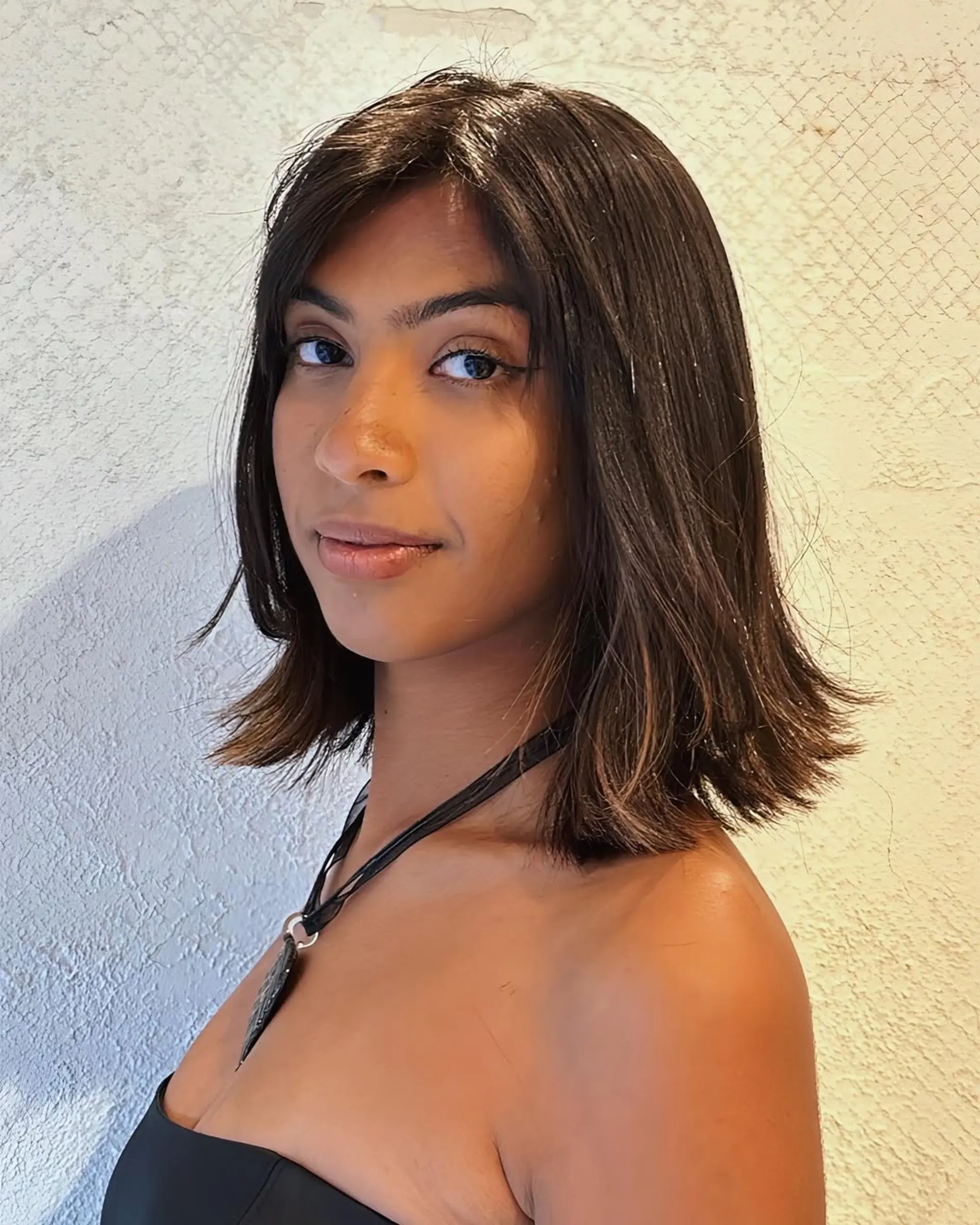 Medium-length, sleek bob with glossy, dark brown hair and soft layers in a subtle A-line cut. 1