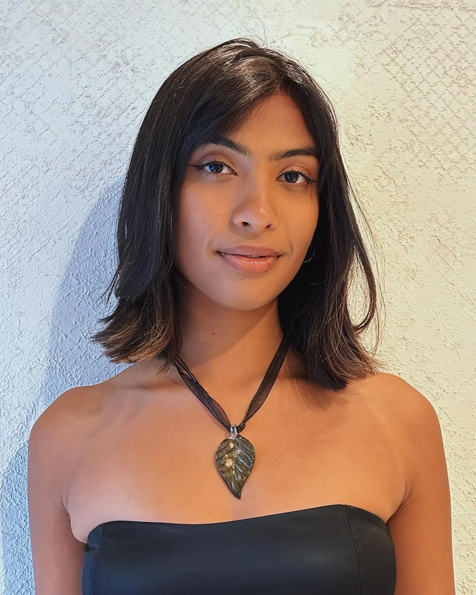 Medium-length, sleek bob with glossy, dark brown hair and soft layers in a subtle A-line cut. 2