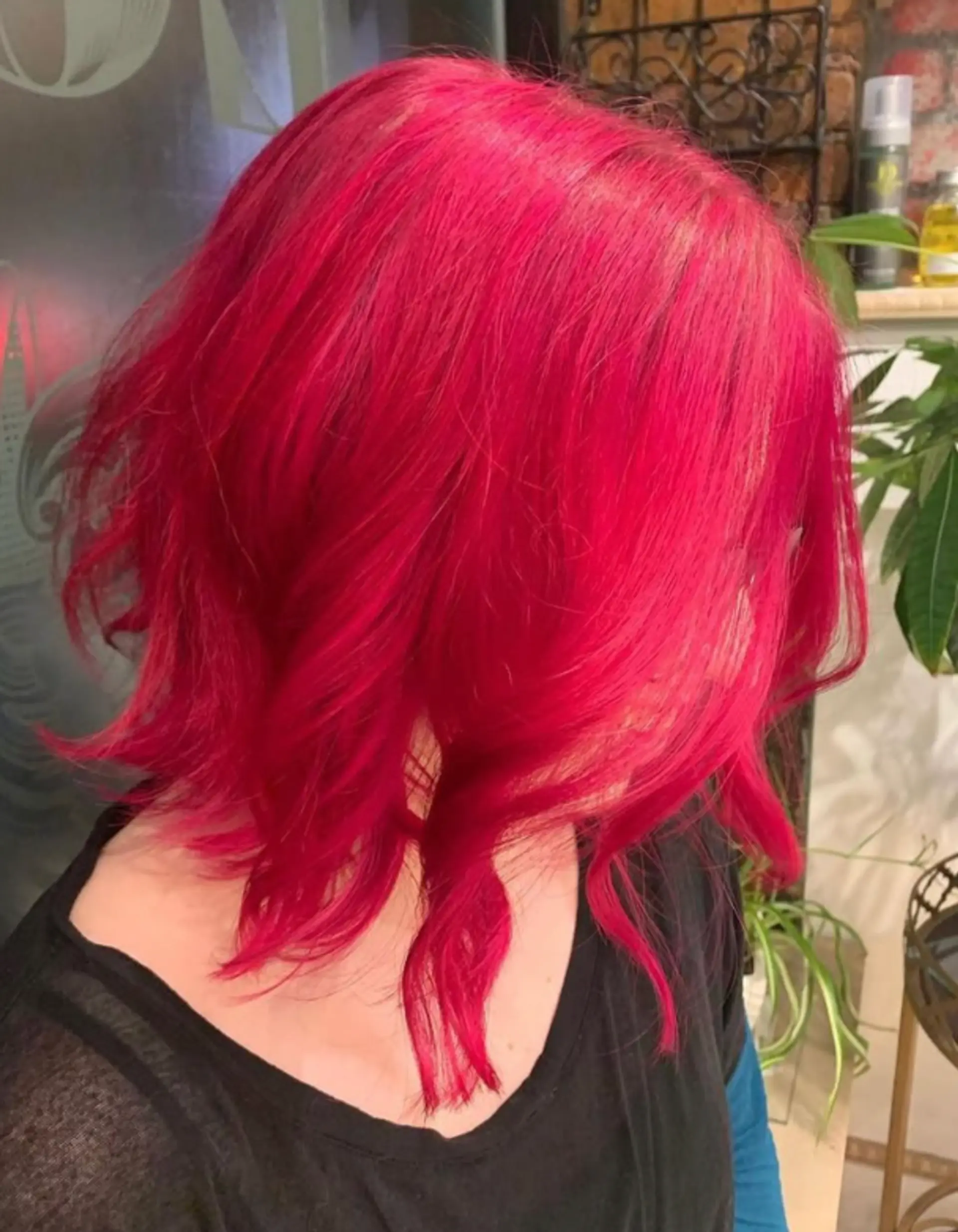 A wavy bob with textured layers and a vibrant pink color. 1
