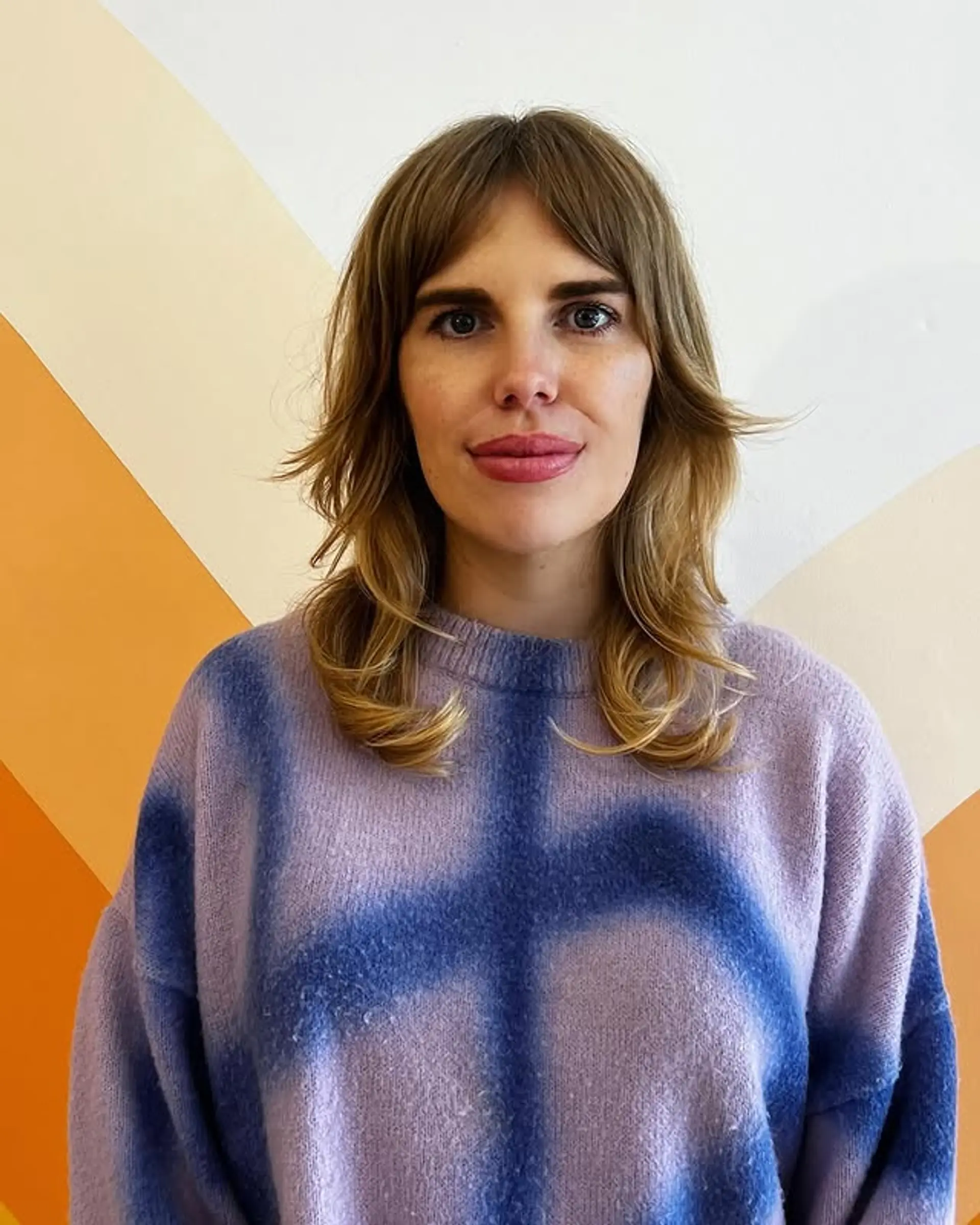 A medium-length shag haircut with layered texture and face-framing curtain bangs. 1