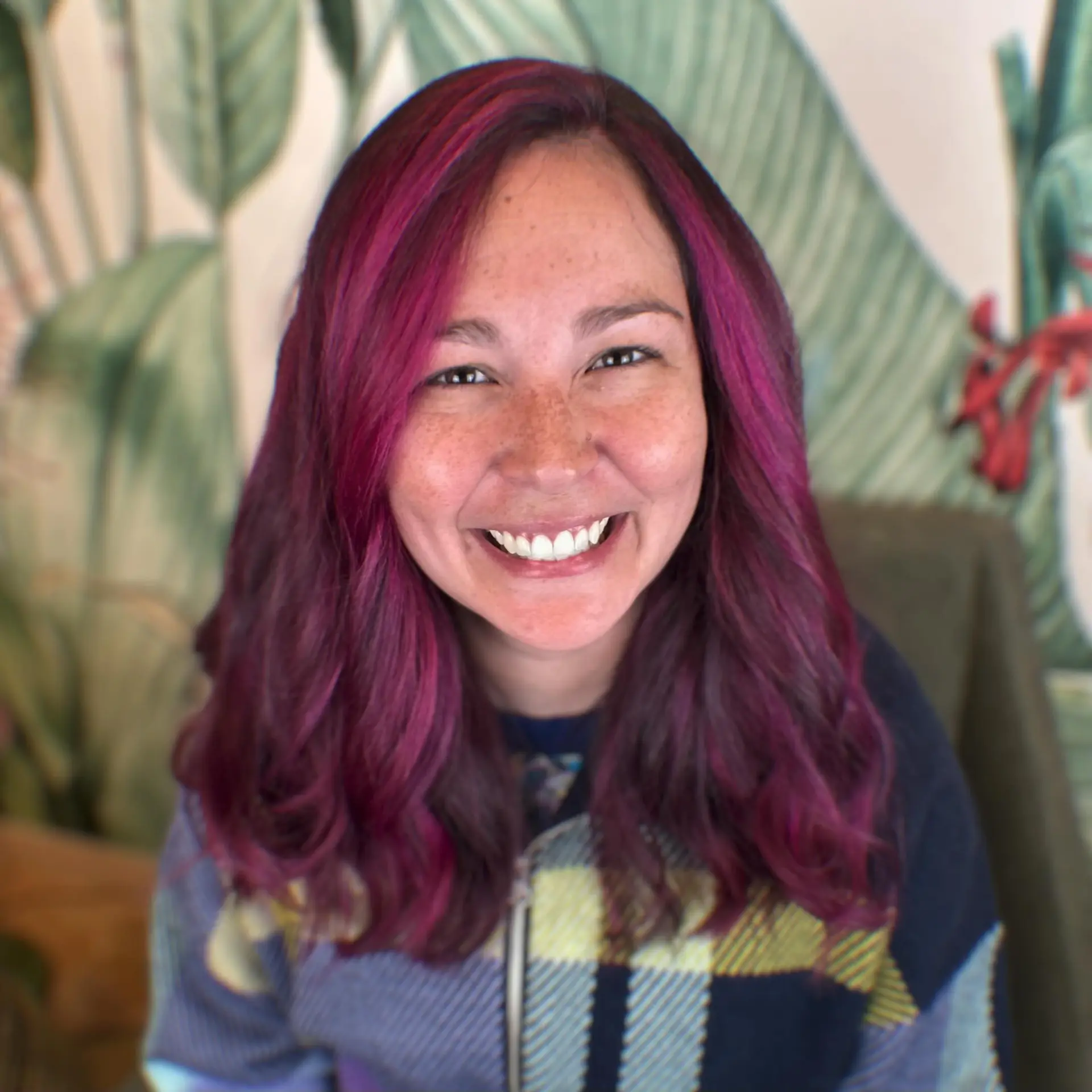 Vibrant magenta and purple lived-in dimensional color styled in loose, voluminous waves. 1