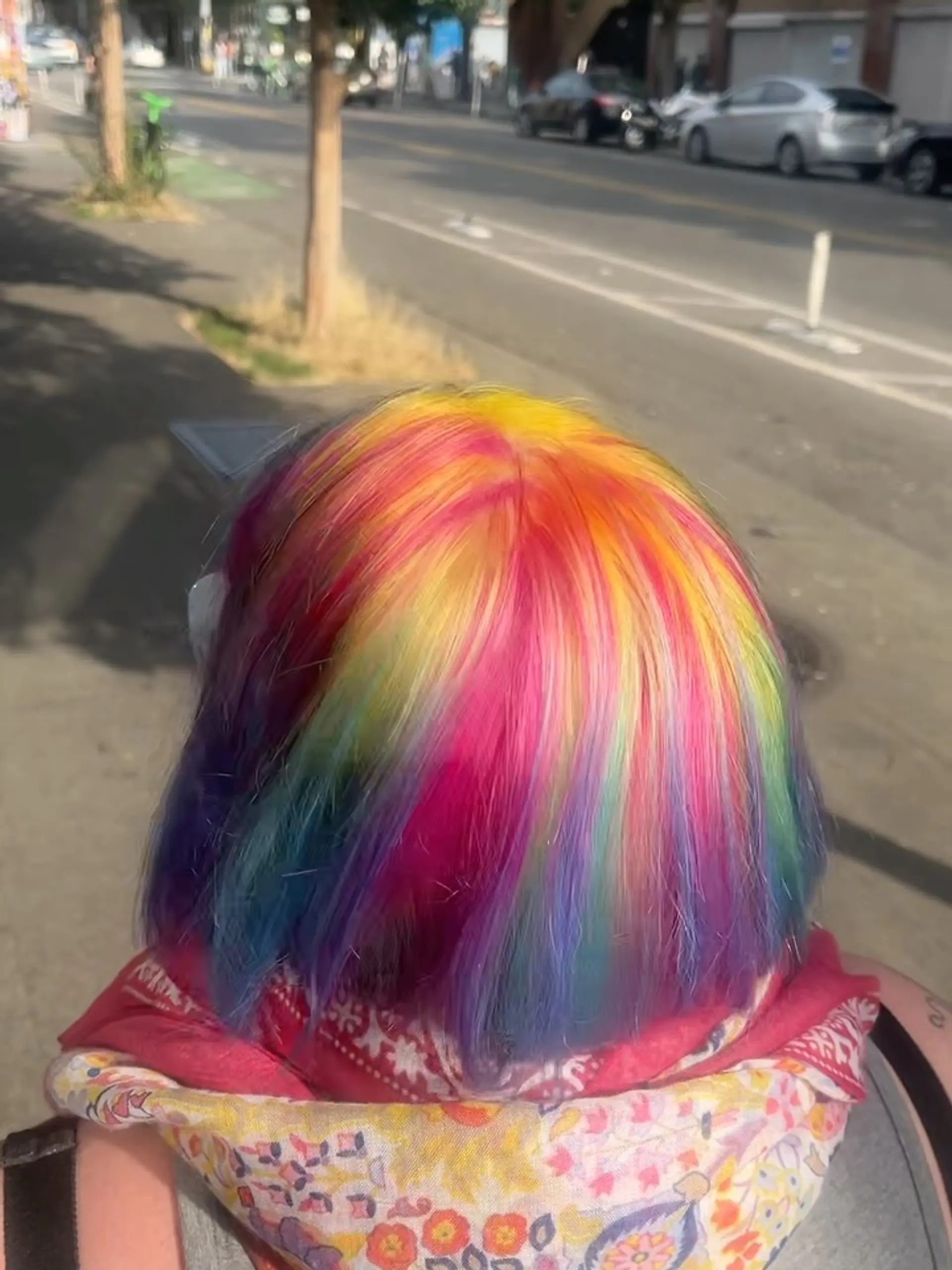 A vibrant multicolored vivid bob featuring a blend of warm yellow and pink tones flowing into cool blues and purples. 1