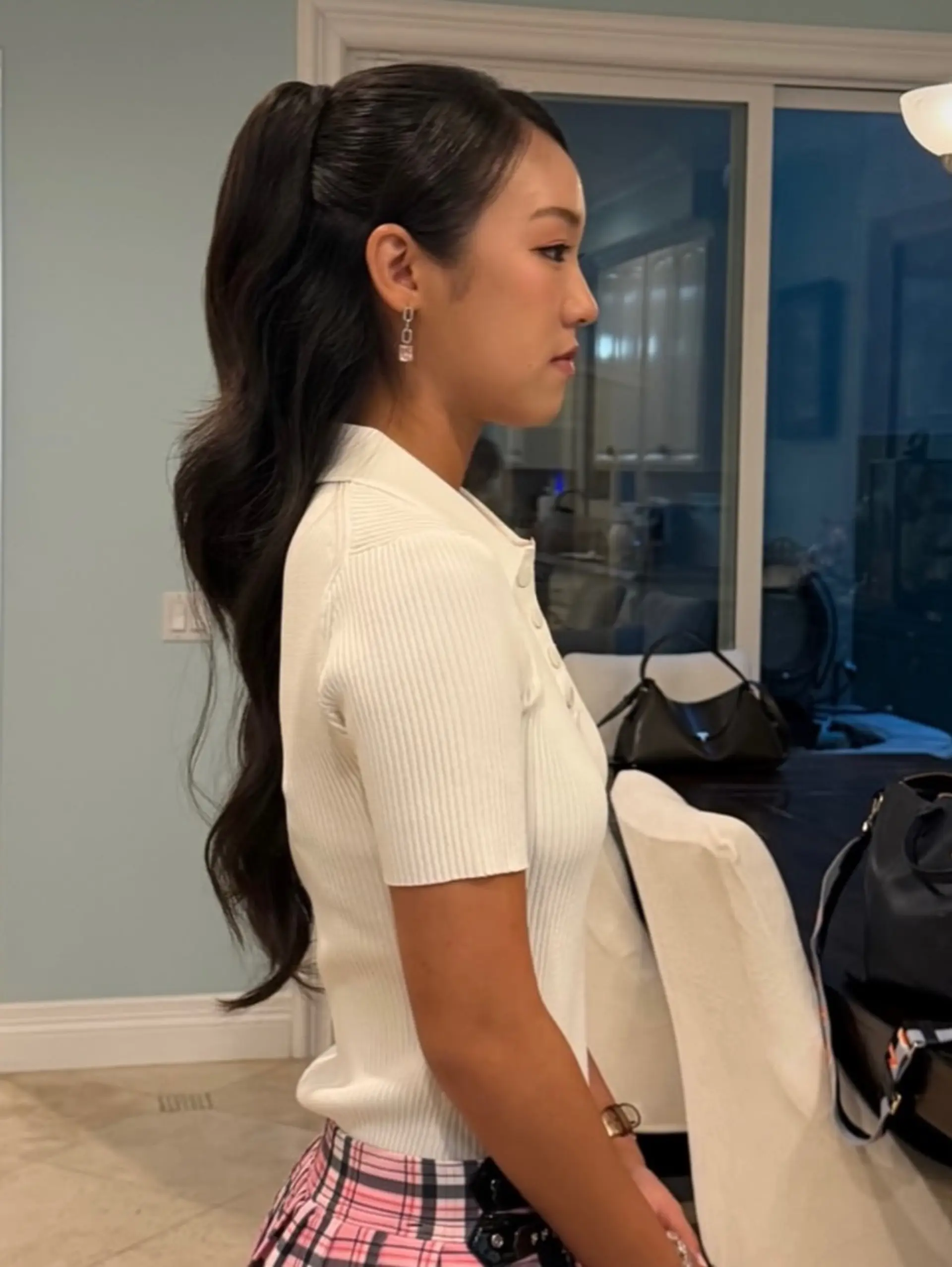 A sleek, polished high ponytail featuring soft, elegant waves flowing down the back. 1