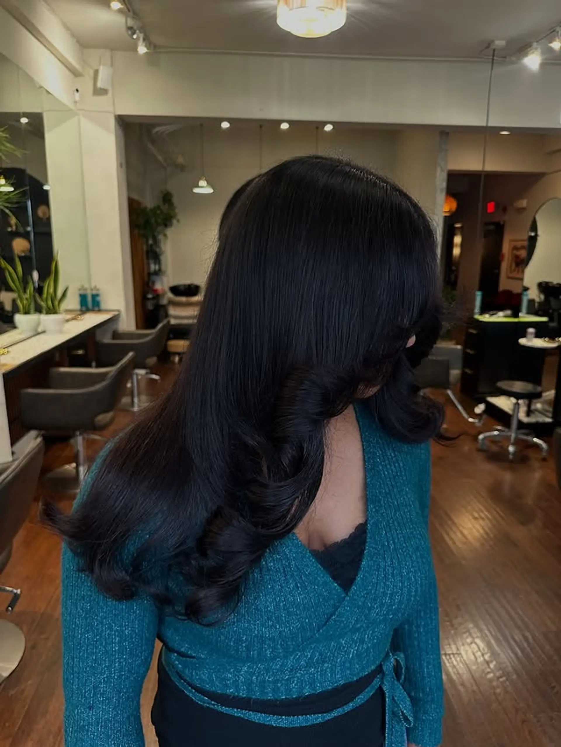 A long, layered hairstyle with face-framing layers and a sleek, shiny finish. 1