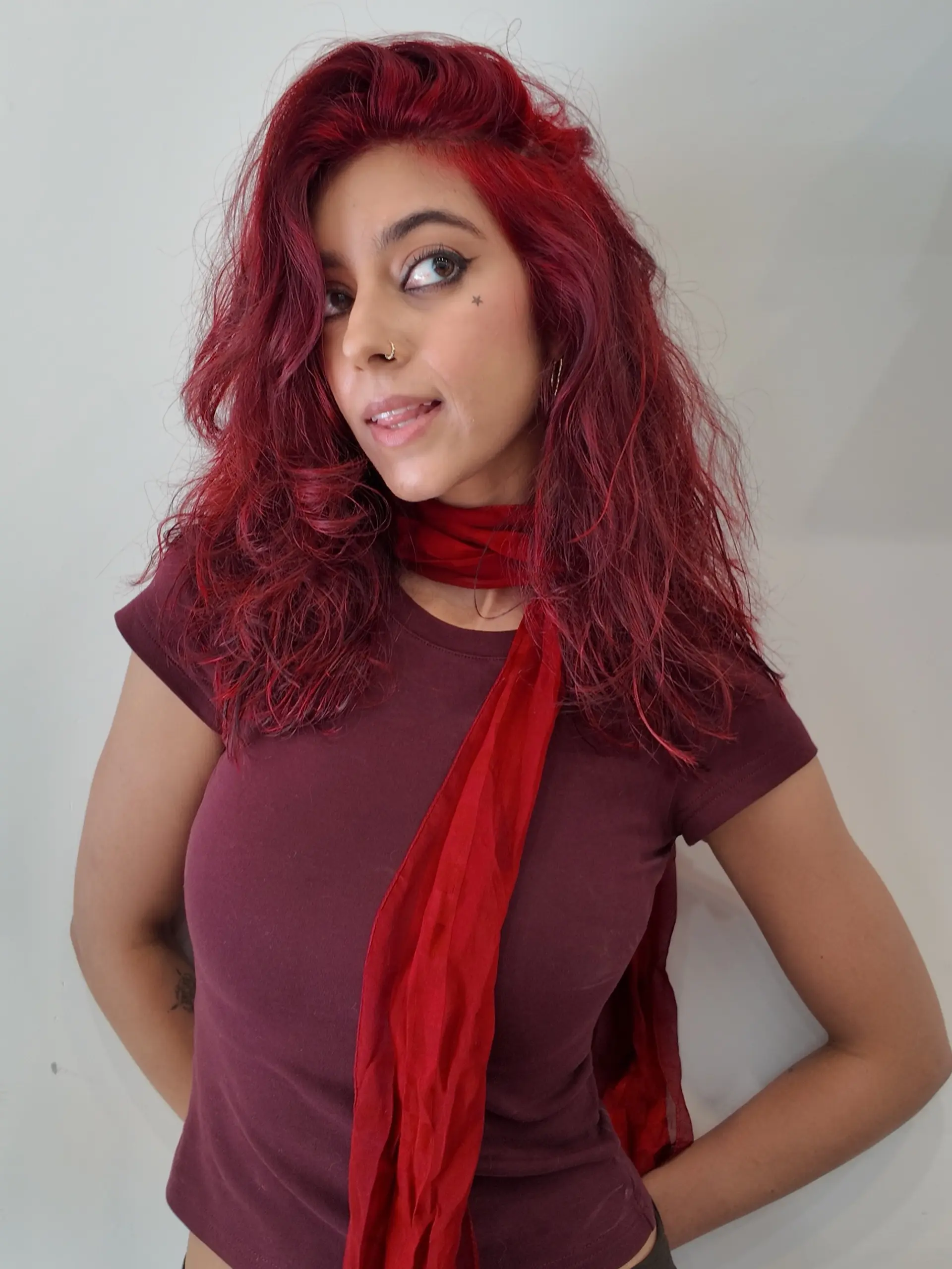 Medium-length vibrant crimson red hair with soft, textured layers and effortless piecey waves. 1