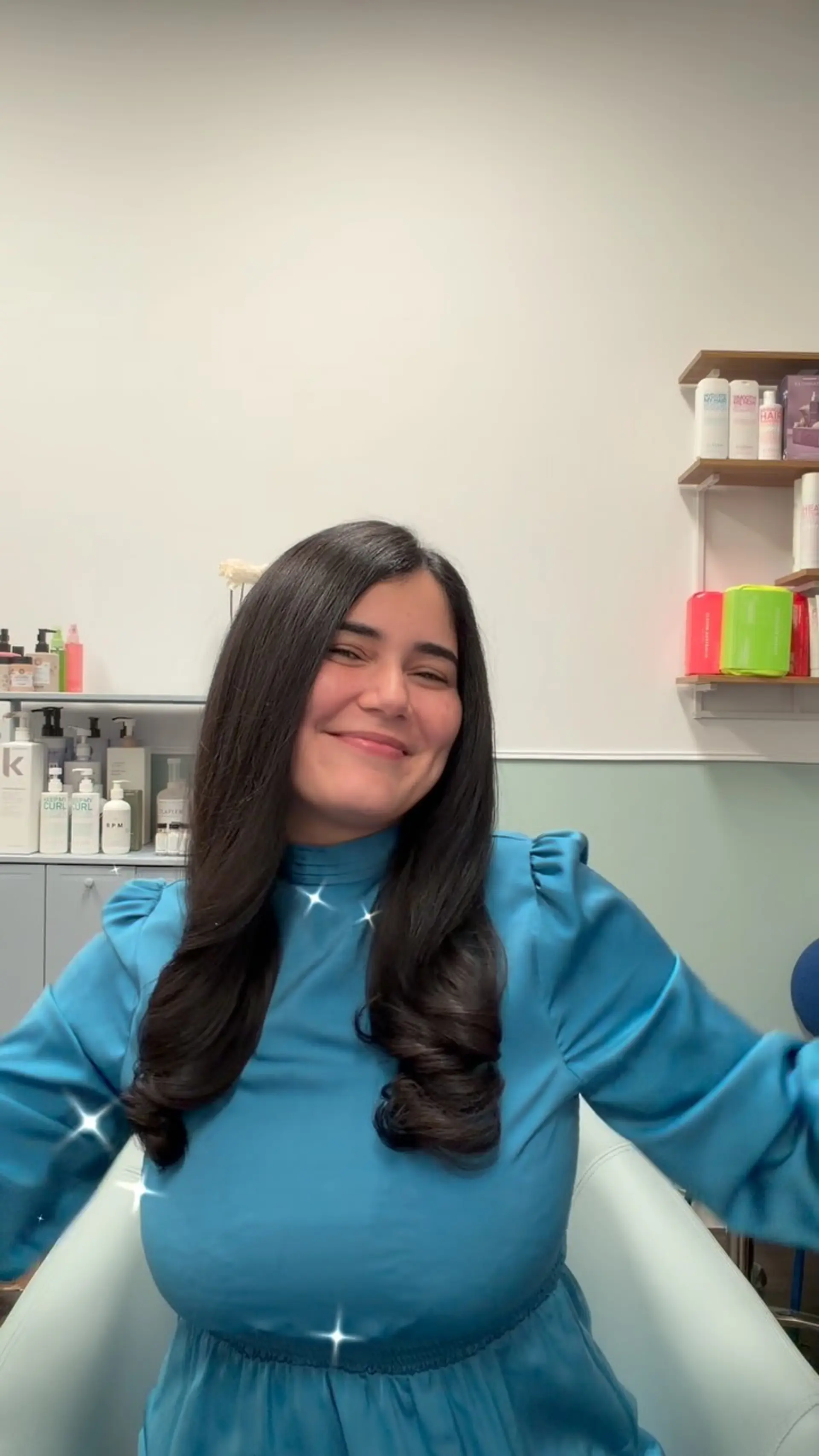 A glossy, long blowout featuring smooth lengths and soft, defined bouncy curls at the ends. Current Blow Out option: $85 before tax. Styling only; haircut and color are not included. 1
