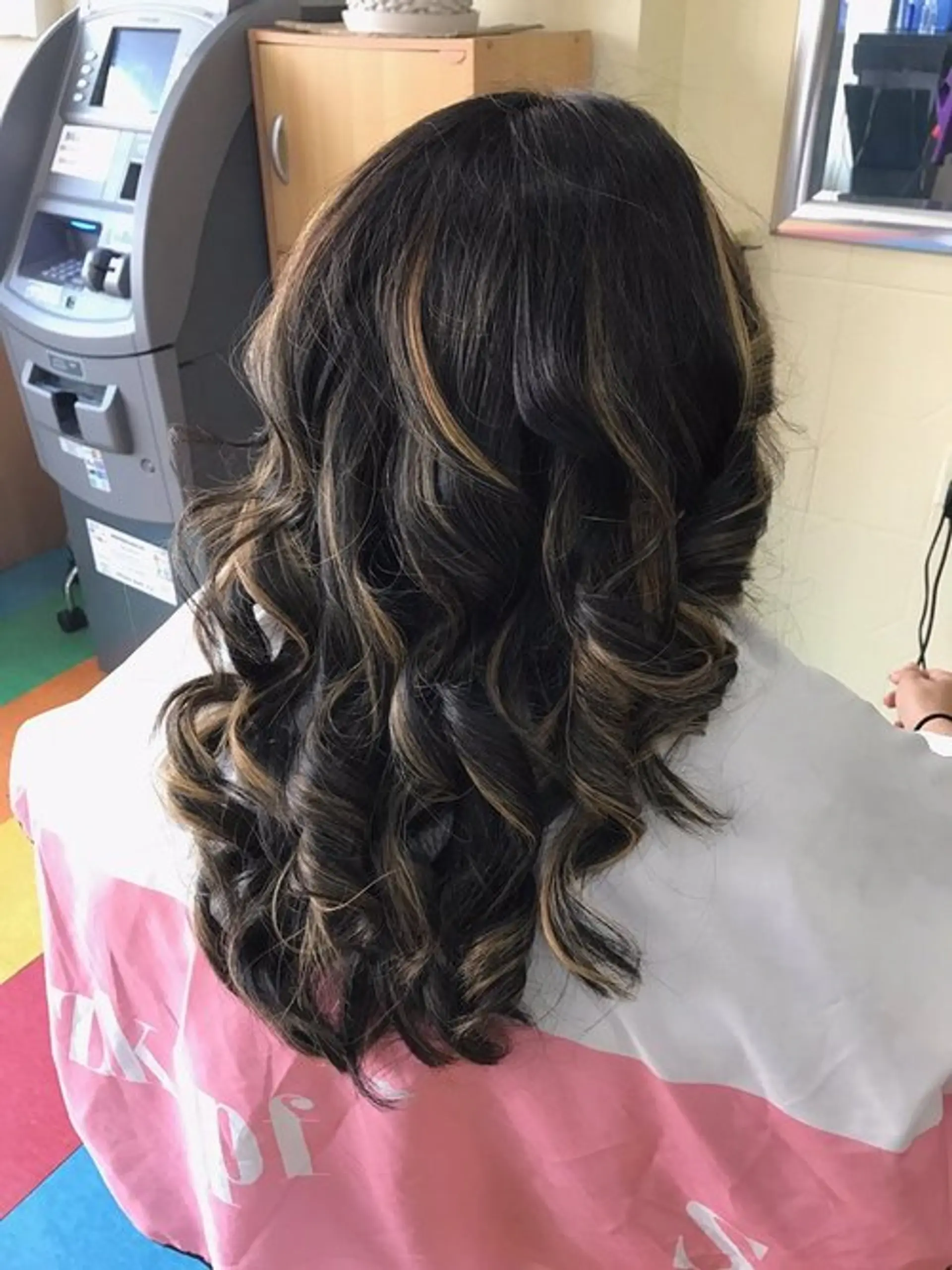 Long wavy hair with a bronde balayage and defined curls. 1