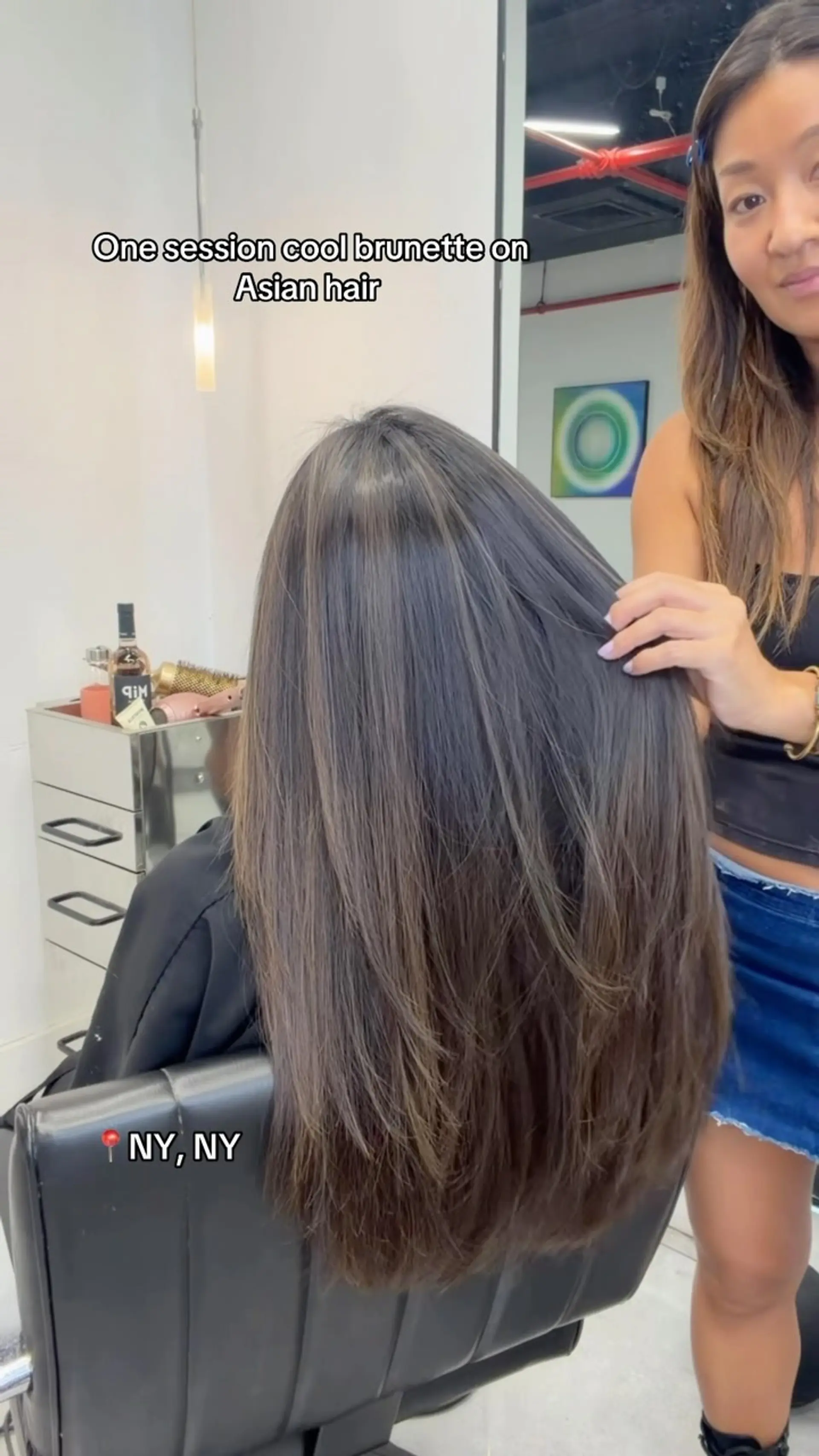 Long straight hair with textured layers and subtle, cool-toned ash brunette highlights. Sakura’s source image is labeled NY, NY. Any displayed estimate uses Cooper West Hollywood’s current starting-price menu; the pictured appointment’s exact service bundle and price are unverified. 1