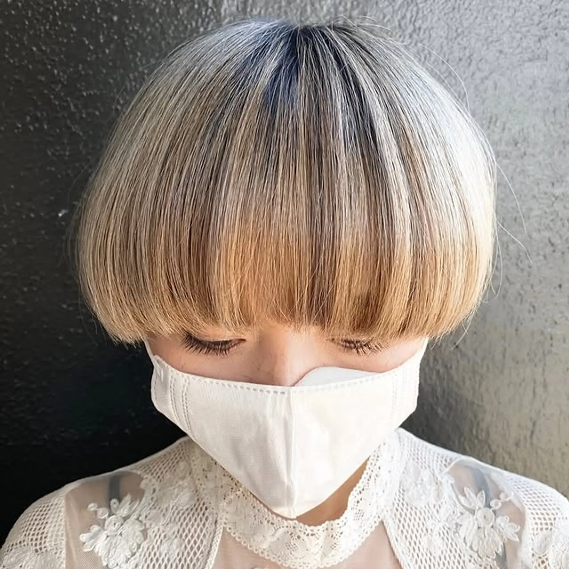 A short, blunt mushroom bob with a smooth, rounded shape. 1