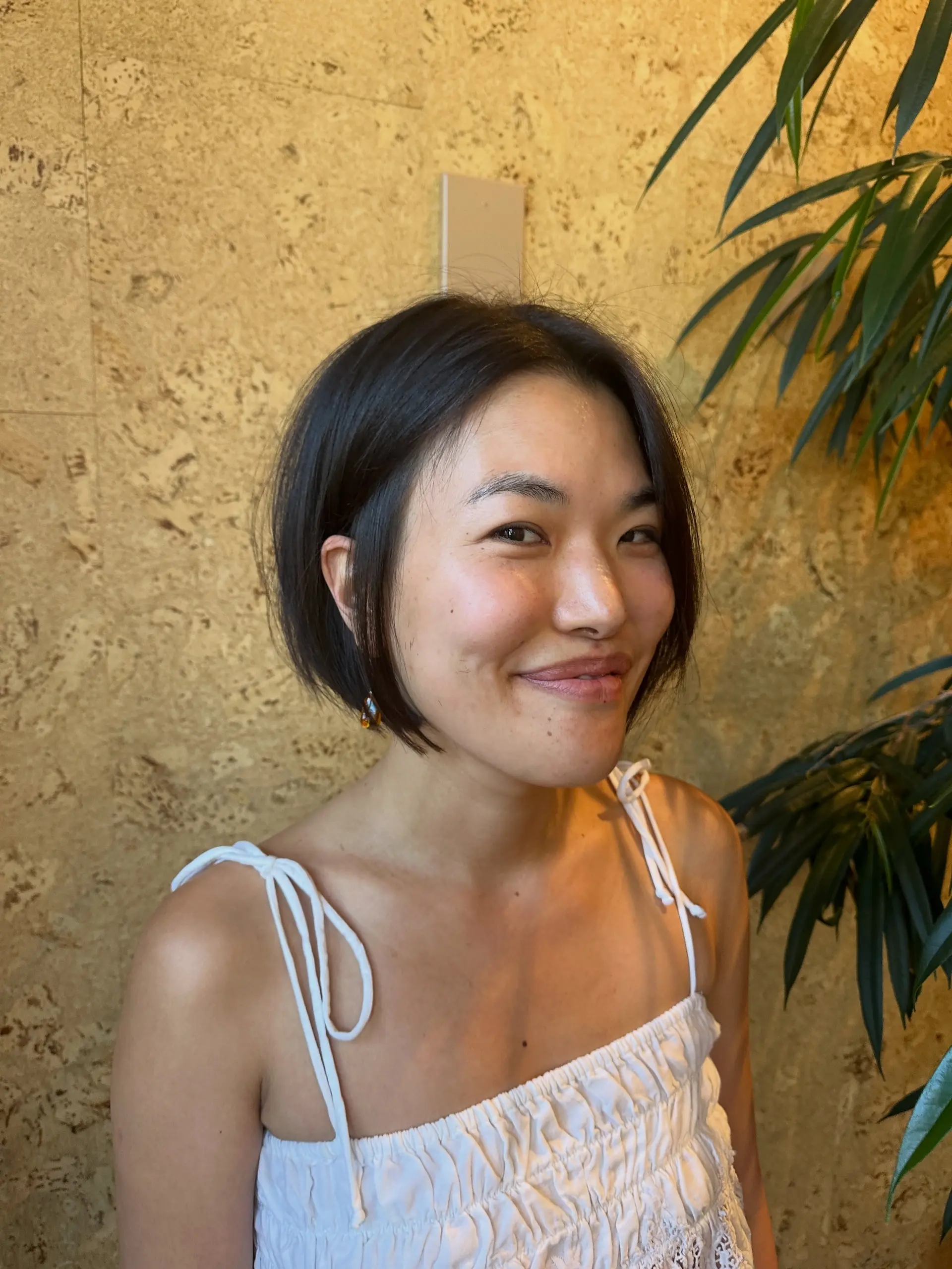 A chic, jaw-length short bob haircut with a soft center part. 1