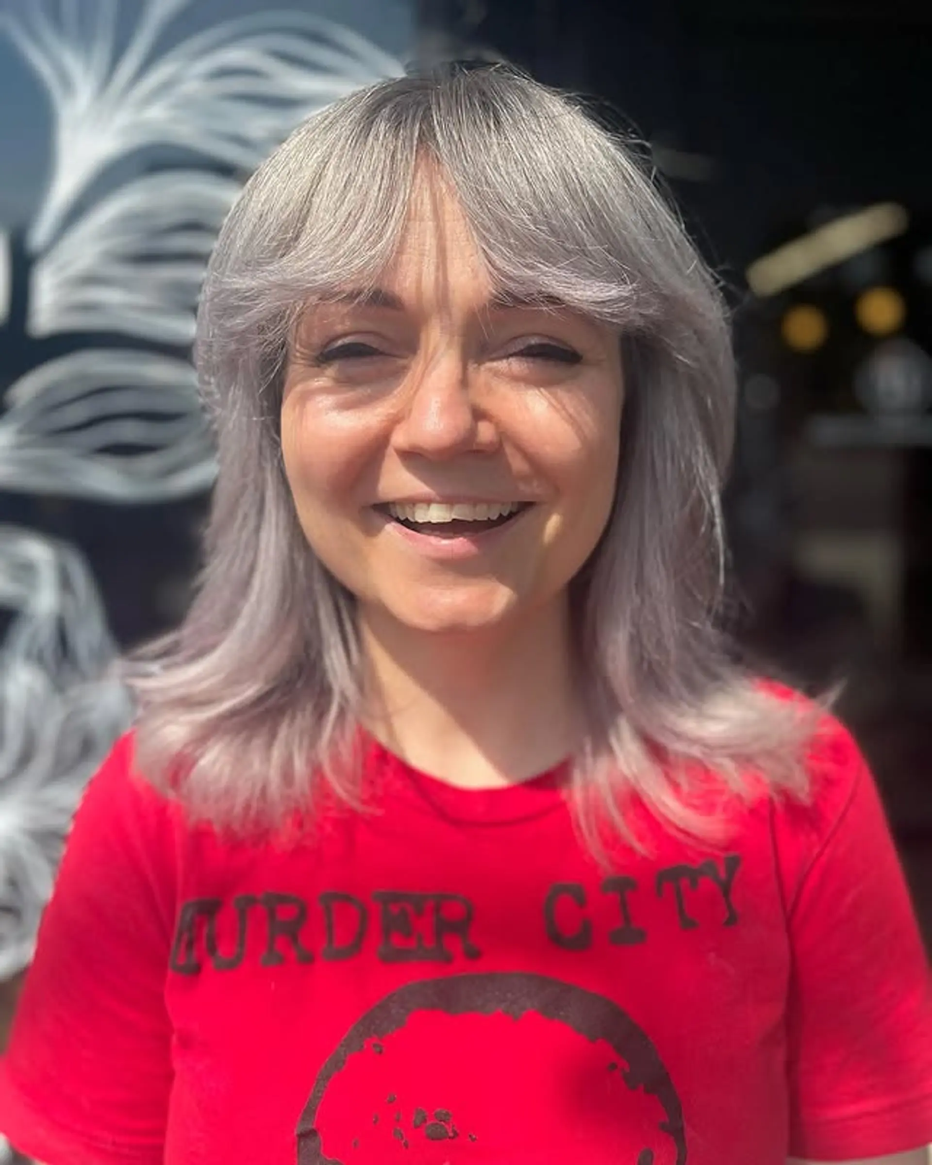 A modern shag haircut with layered texture and face-framing bangs. 1