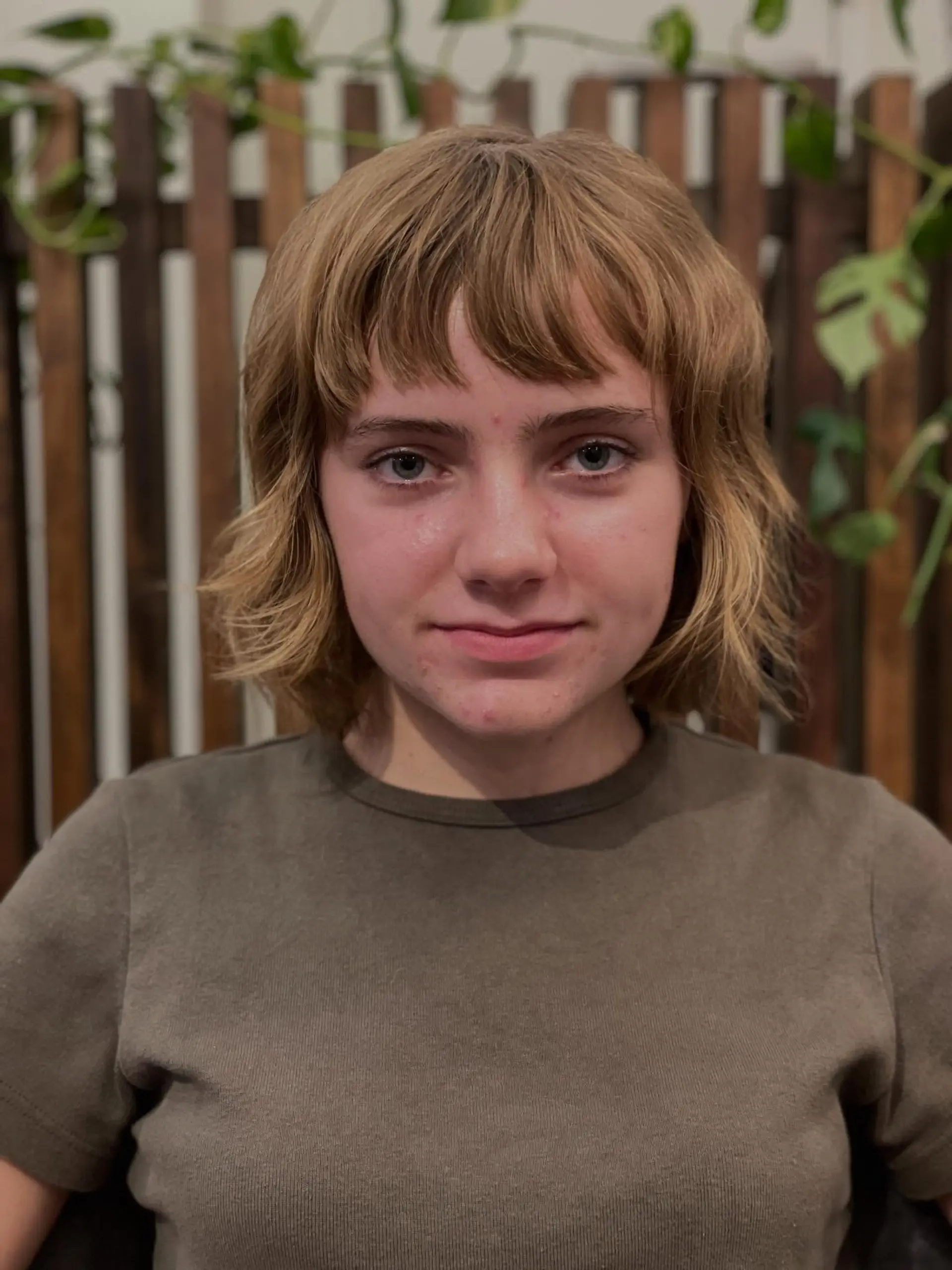 A textured bixie cut featuring short, feathered bangs and soft wavy layers resting just at the jawline. 1