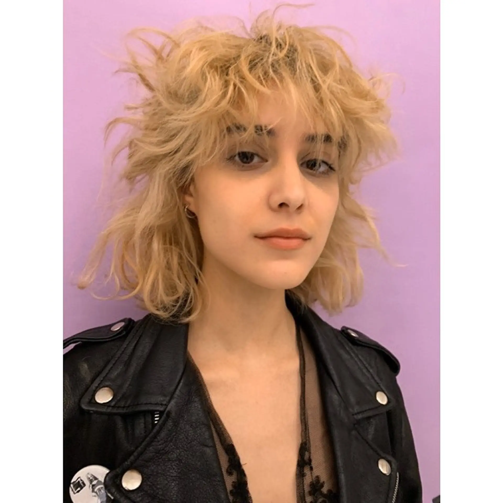 A trendy medium-length shaggy bob with choppy layers and blunt bangs for a textured look. 1