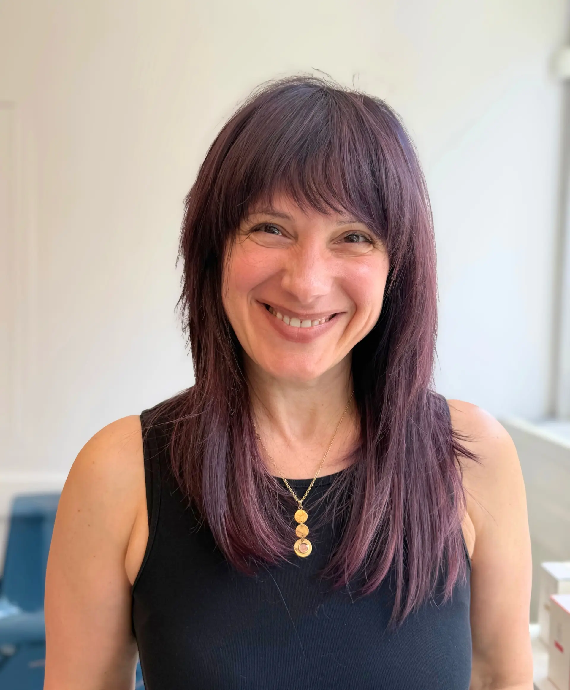Long straight dark plum-purple hair with full front bangs and textured face-framing layers. 1