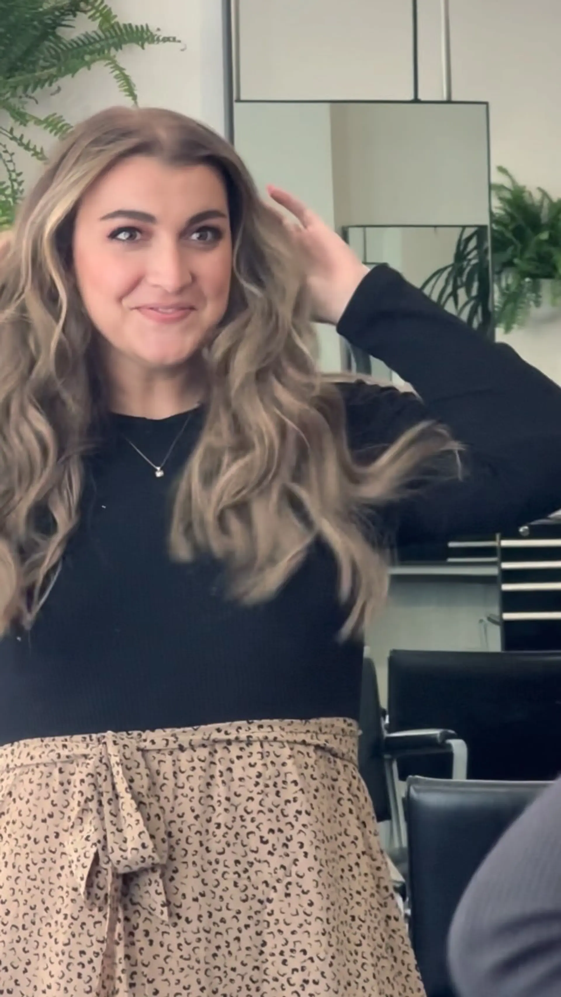 Long ash blonde and light brown hair styled in soft, bouncy waves with a voluminous blowout finish. 1