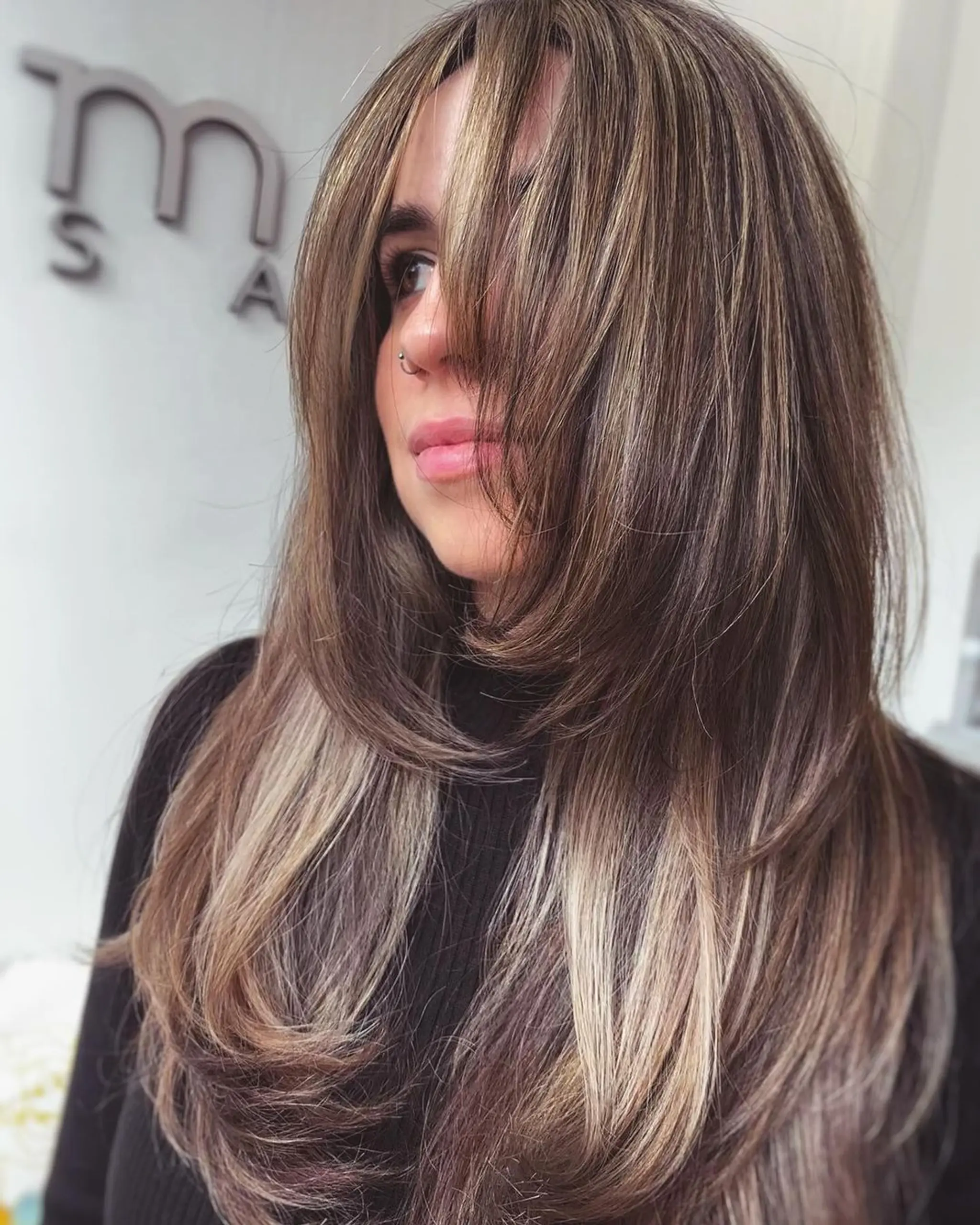 Long, straight hair featuring layered cut with face-framing layers and blonde highlights.