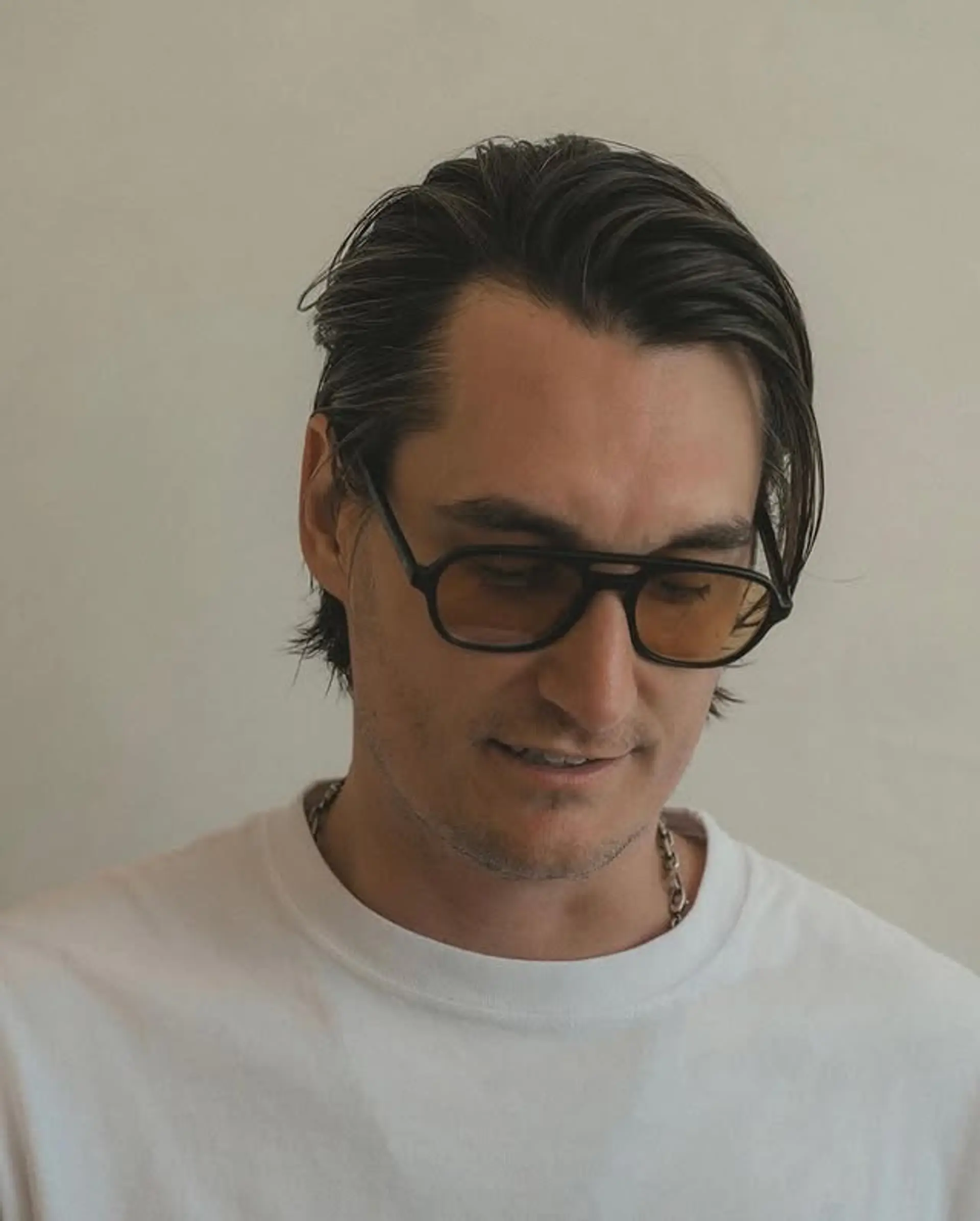 Slicked back medium length flow hairstyle with a modern touch. 1