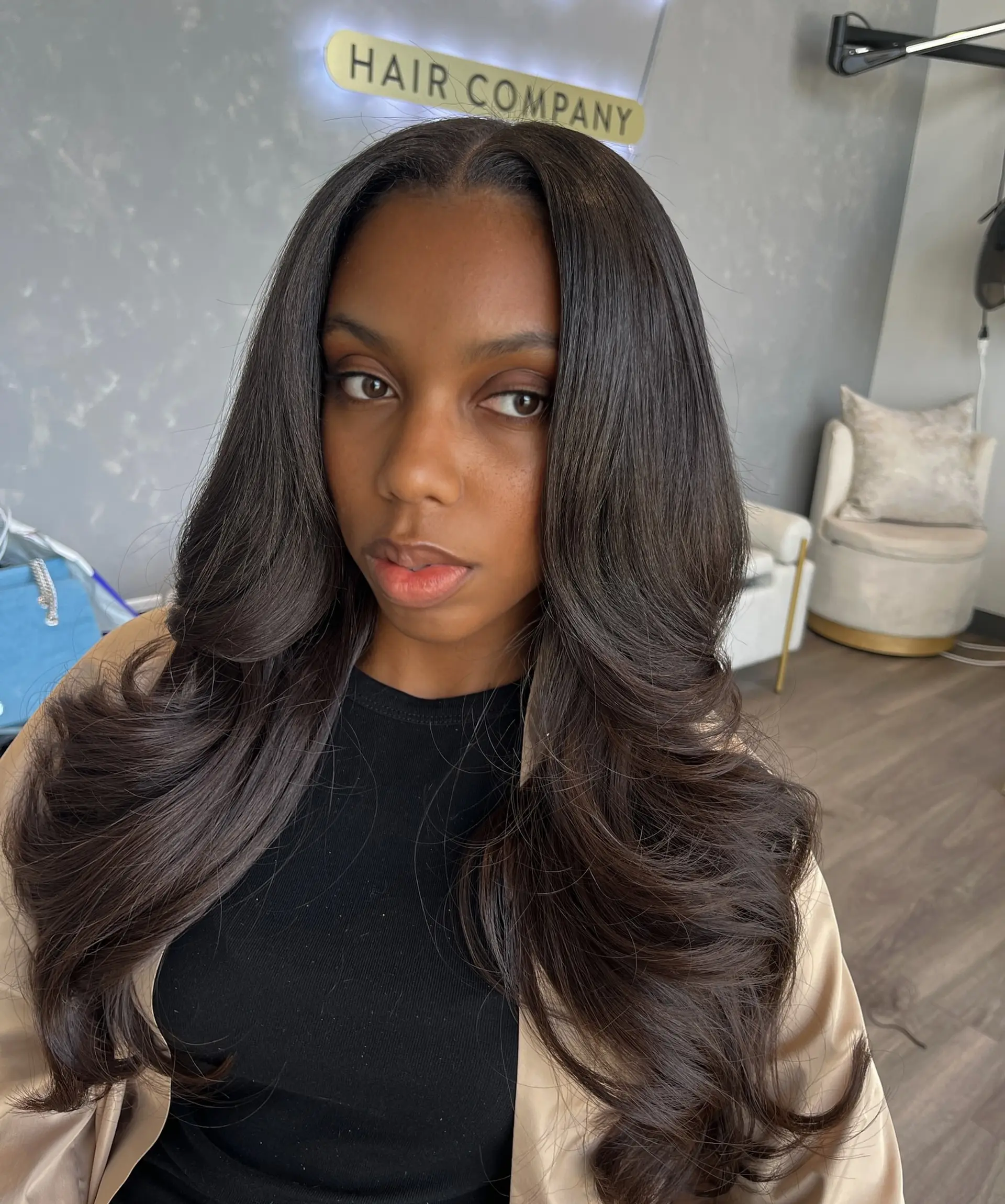 A sleek and polished long layered blowout with defined curls. 1