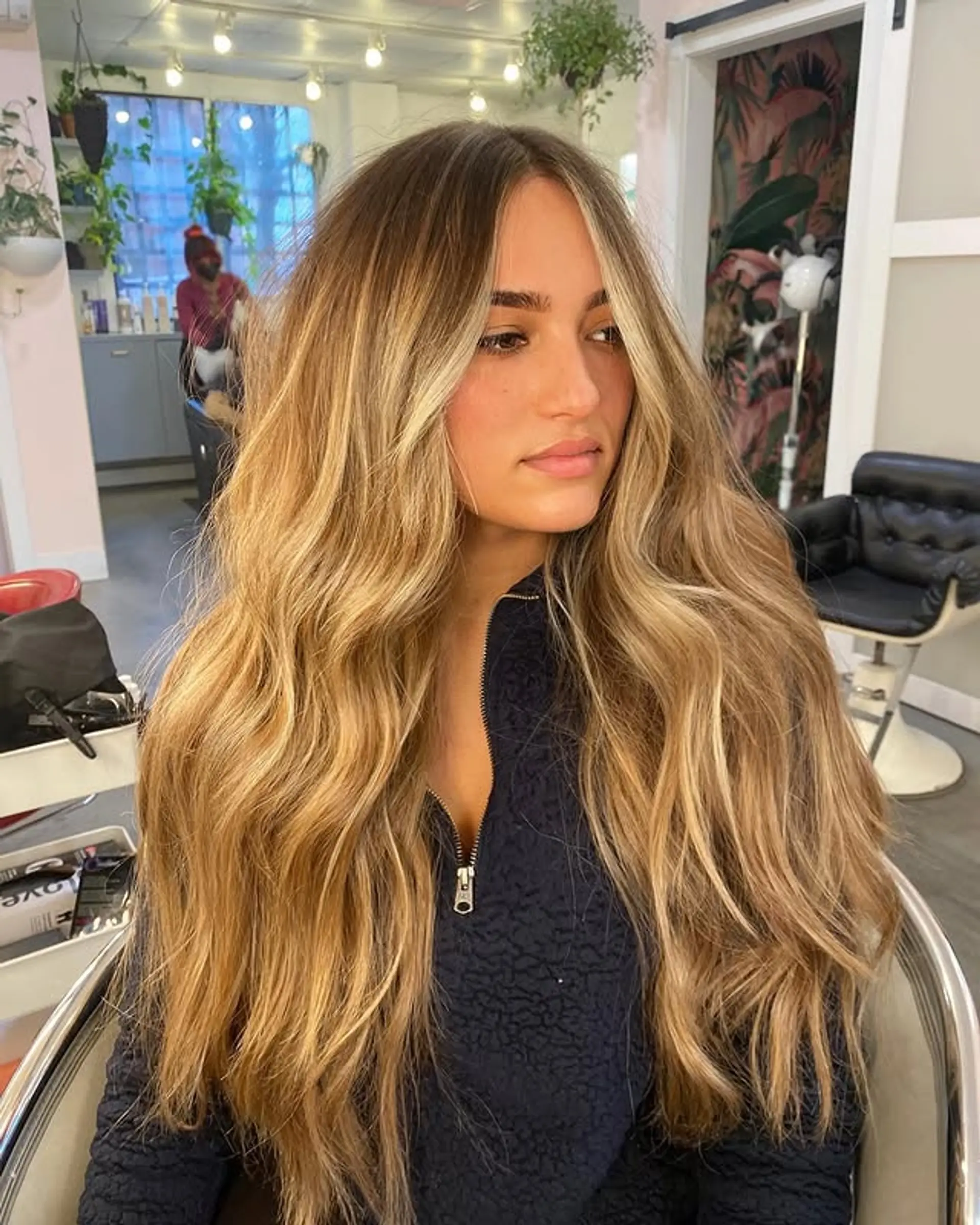 Long, wavy bronde balayage with face-framing highlights and root shadow. 1