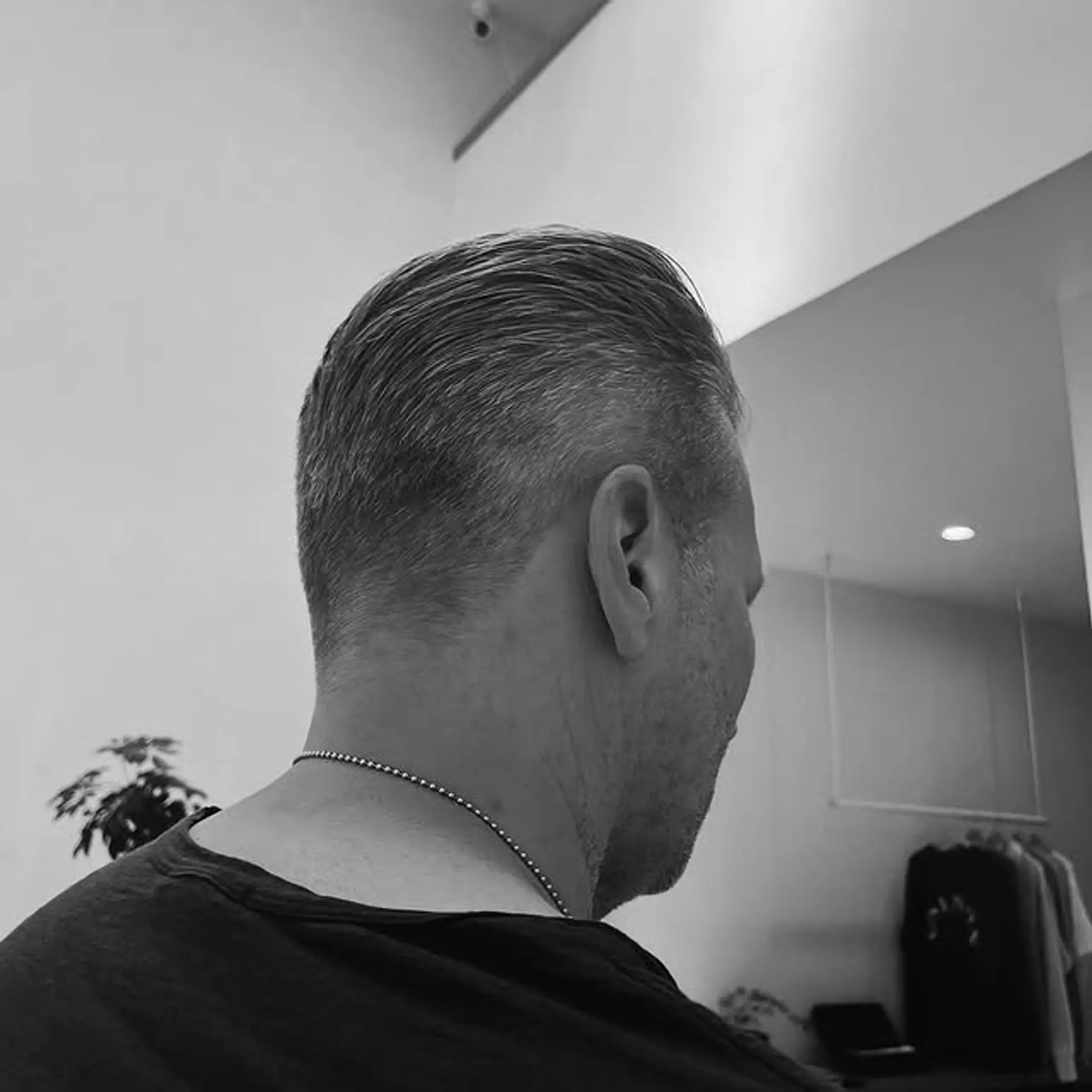 A short, slicked-back taper fade for men. 1
