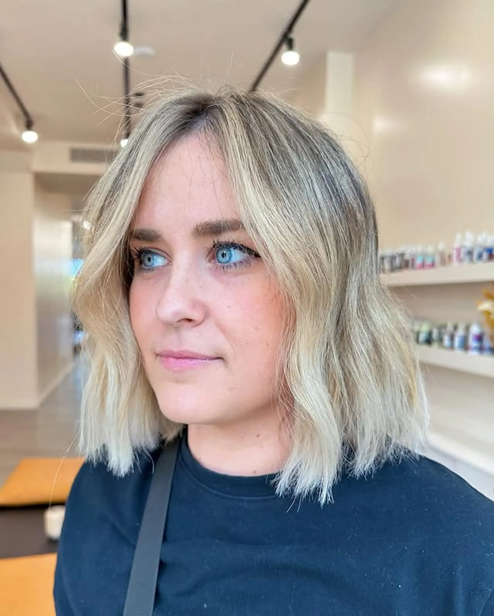 A wavy lob with icy blonde balayage and shadow roots. 1