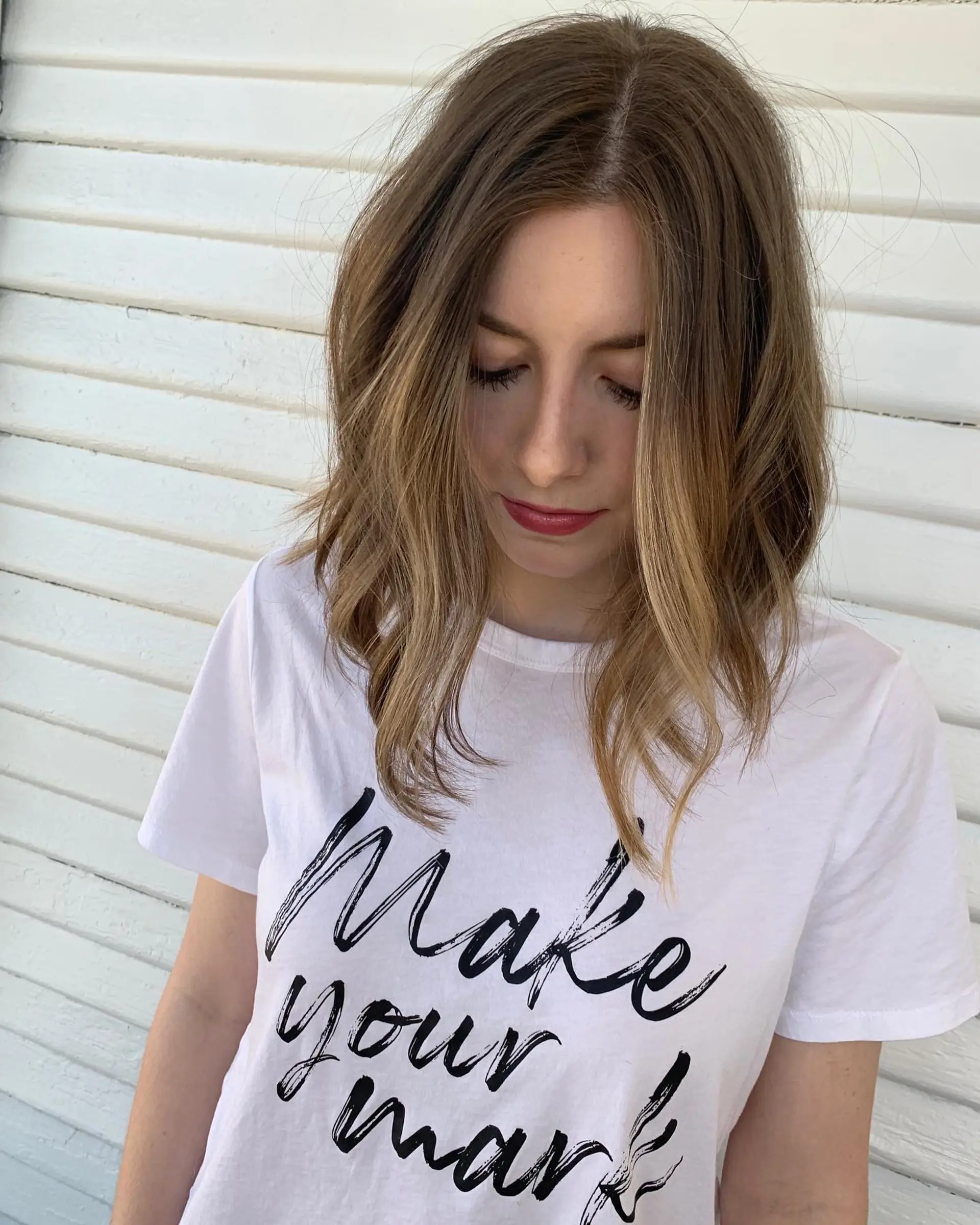 A collarbone-length textured long bob styled with soft, loose beachy waves. 1