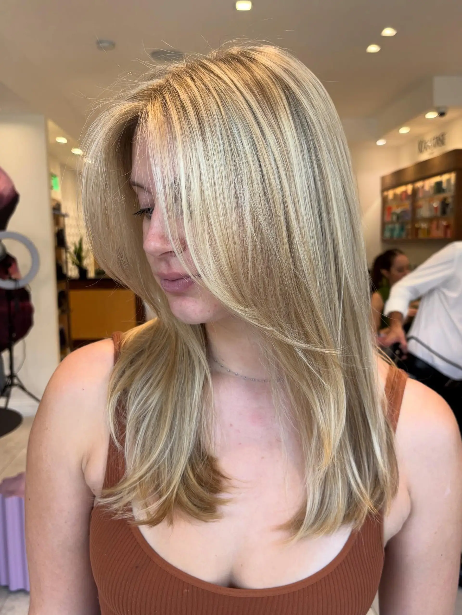 Straight long hair featuring seamless butter blonde highlights and soft, face-framing layers. 1