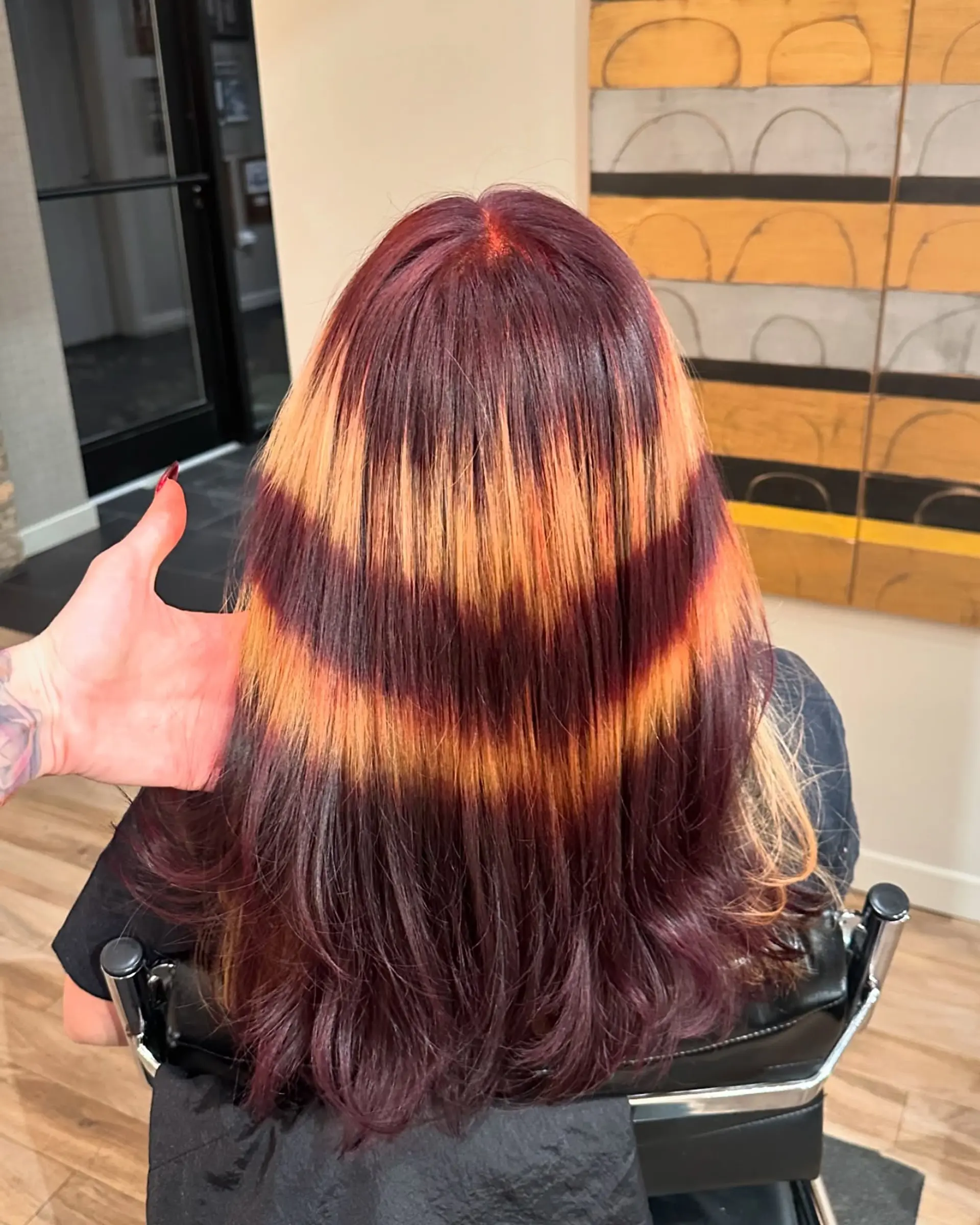 Long layered hairstyle with copper and burgundy stripes. 1