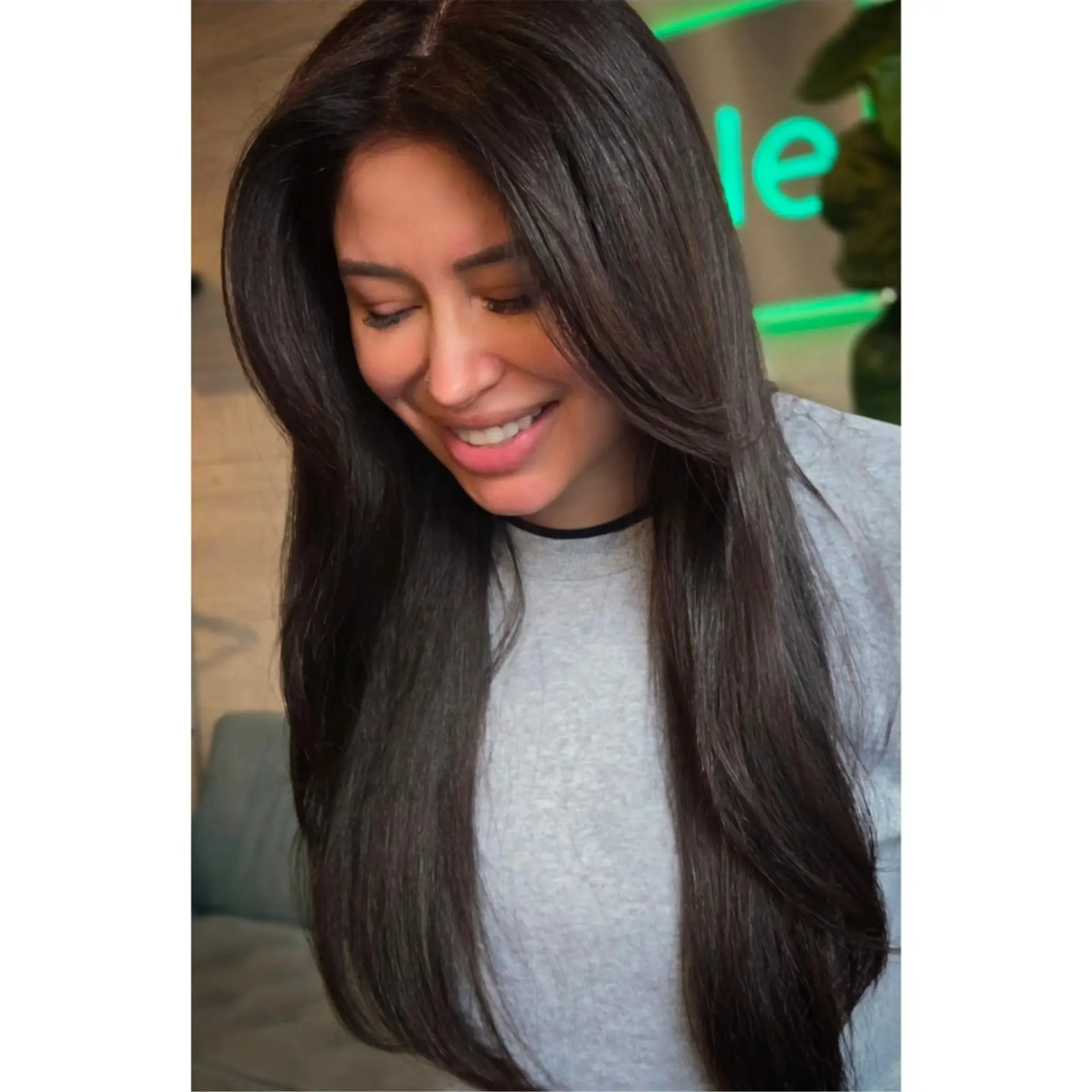 Long, glossy dark brown hair styled into a smooth, voluminous blowout with soft face-framing curtain layers. 1