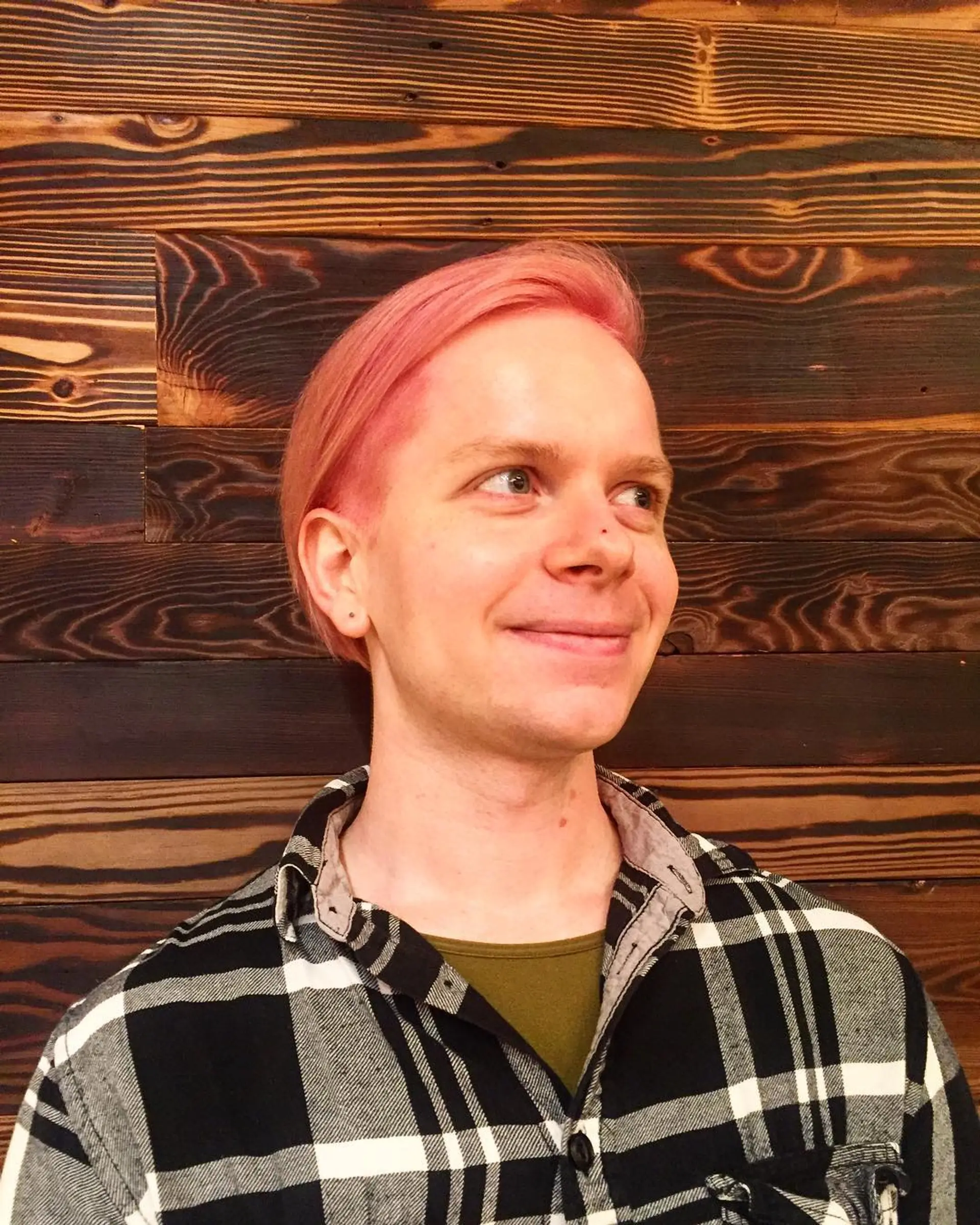 Short, sleek haircut with a side part, dyed a trendy millennial pink. 1