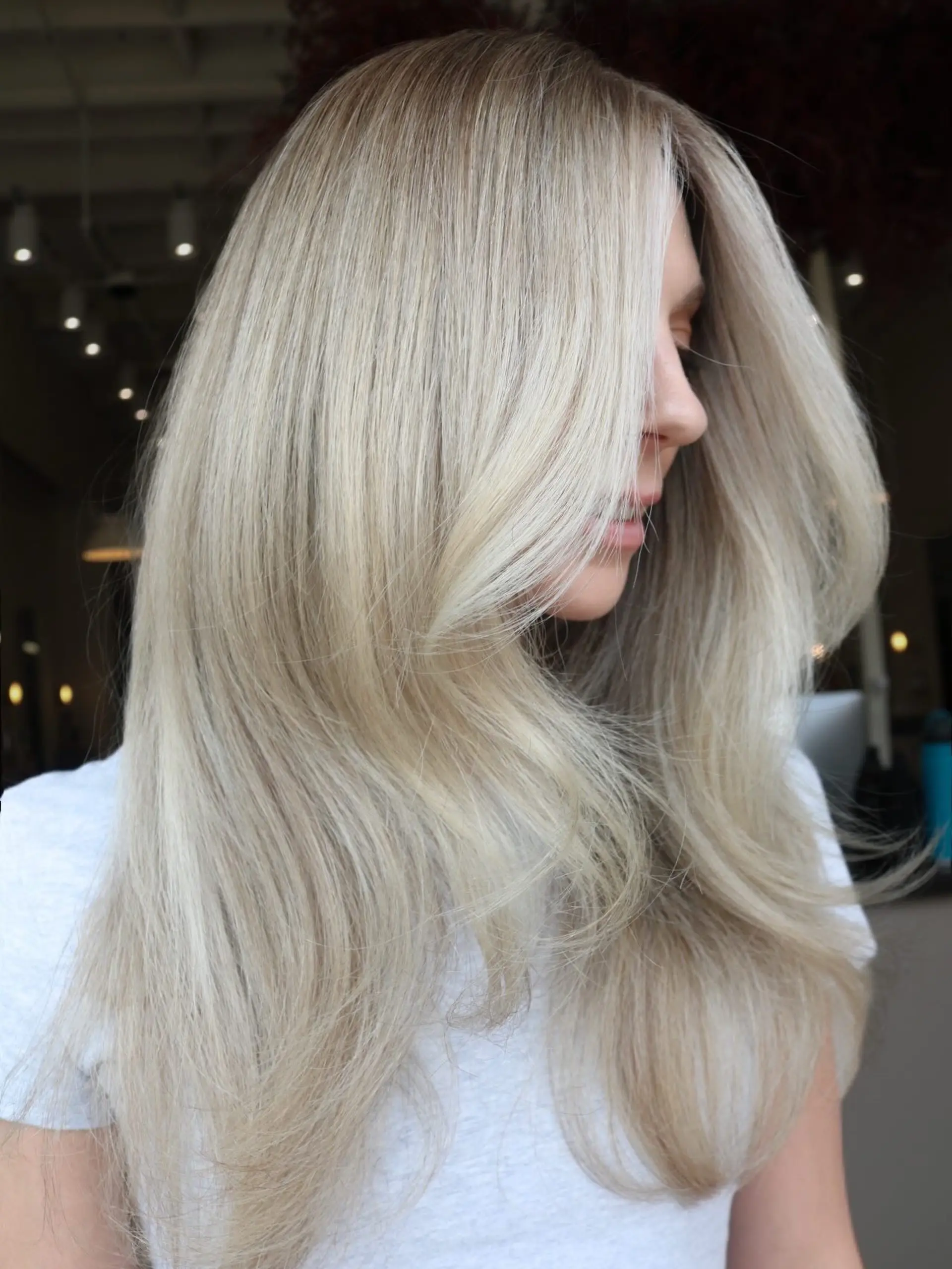 Long, bright neutral blonde hair styled into a voluminous blowout with soft face-framing layers. 1