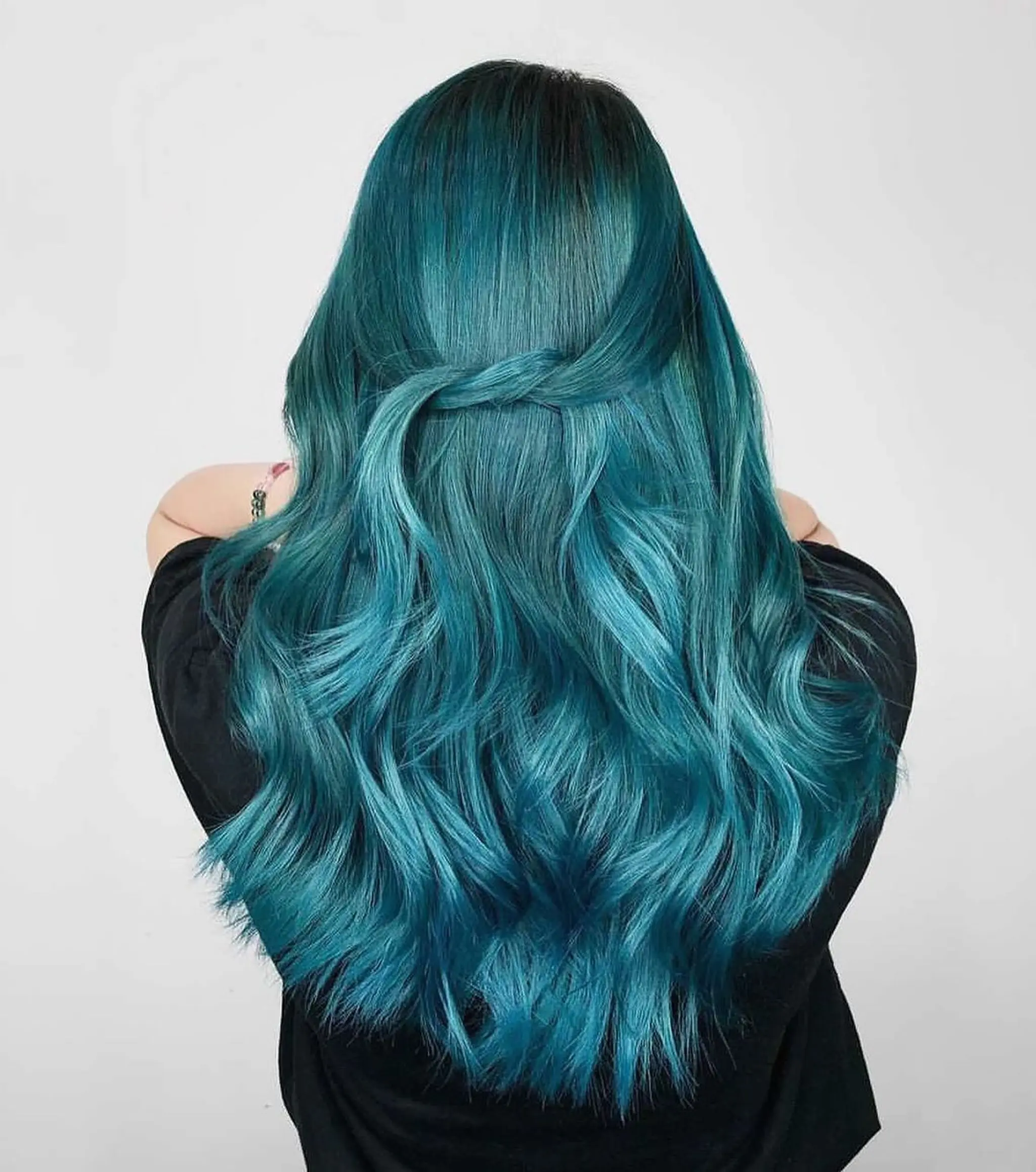 The hairstyle features long, wavy hair in teal and aqua blue colors, with a braided crown blending into loose waves.
Stylist - @xcellent_jason