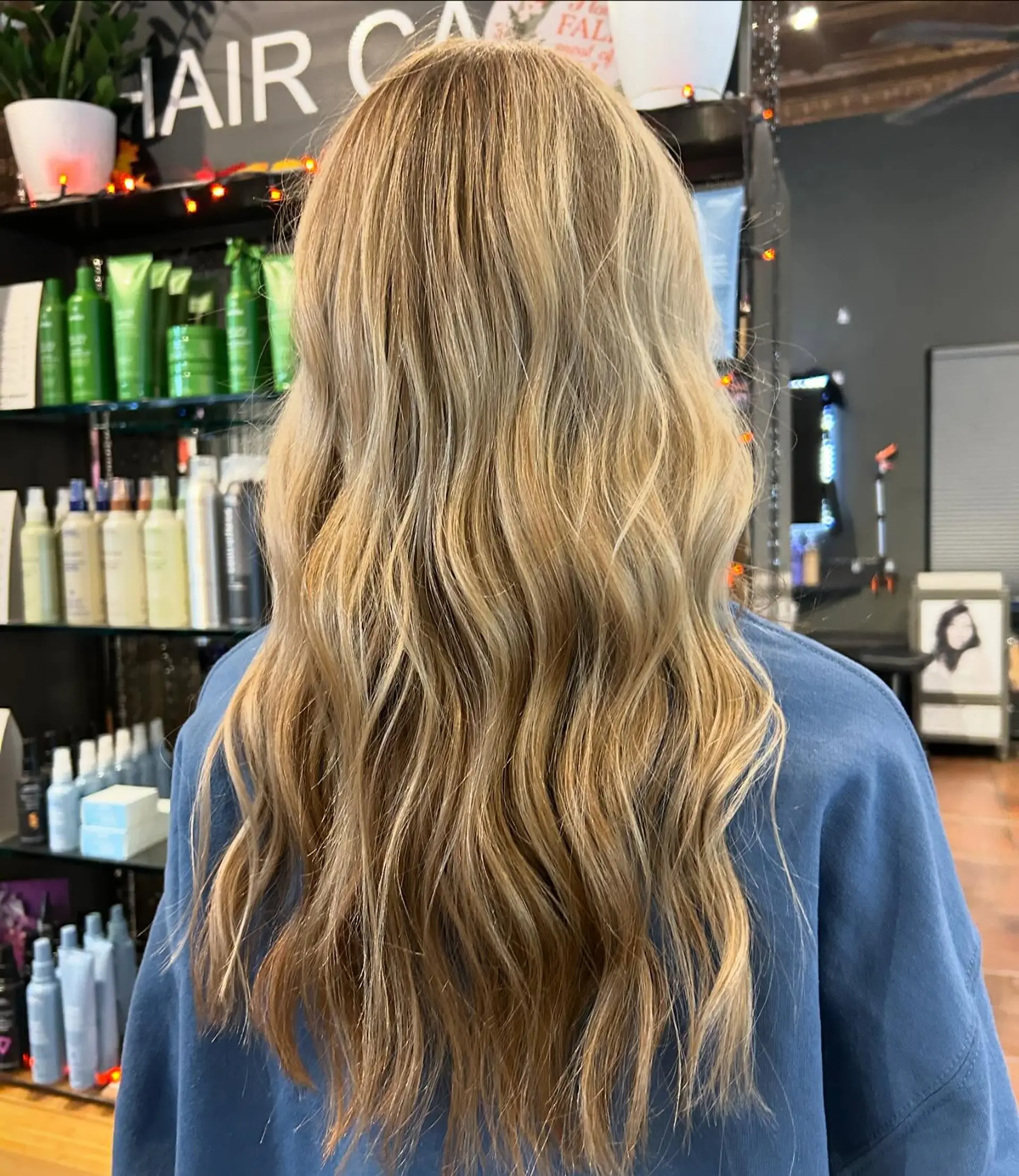 Long dimensional blonde hair styled into effortless, loose waves. 1