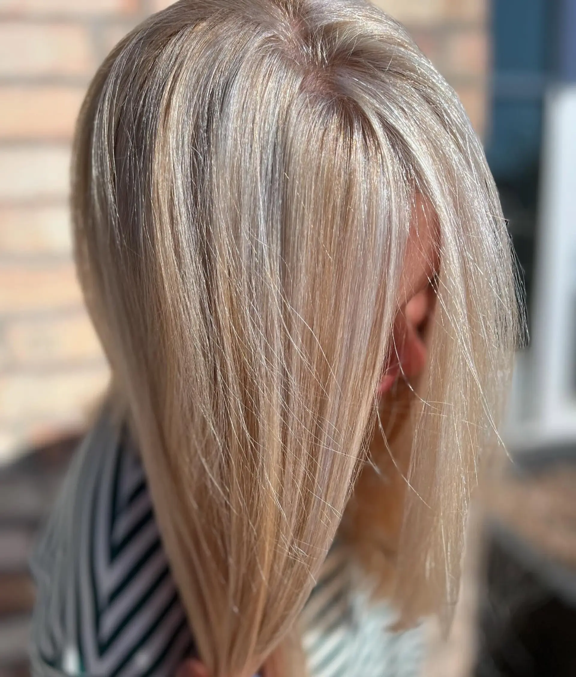 Straight medium-length hair featuring bright, seamless blonde highlights from roots to ends. 1
