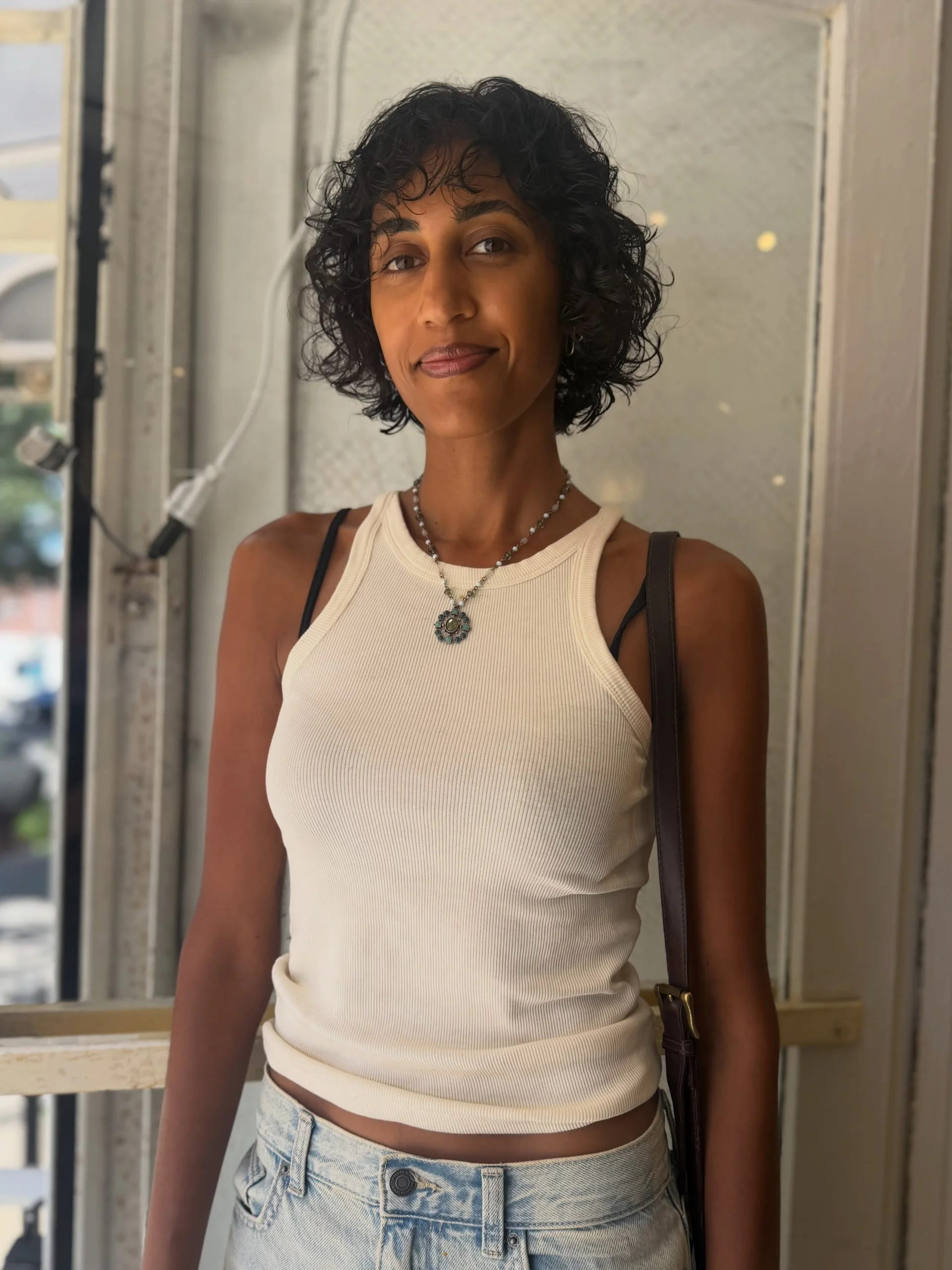 A curly bob haircut with defined, bouncy, dark brown curls that fall around the shoulders. - Preview 1