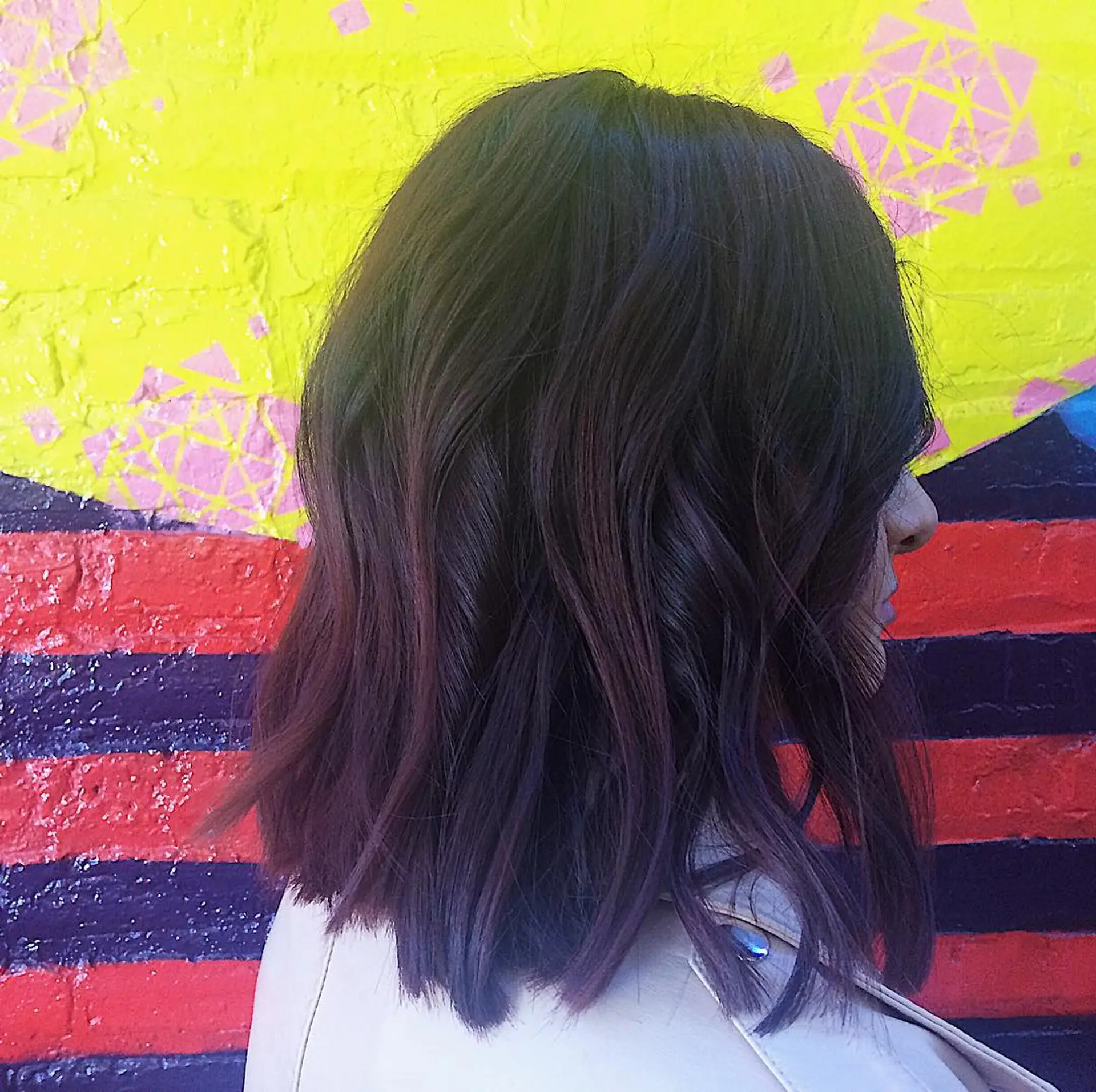 A medium-length wavy bob with subtle layers for added movement and texture. 2