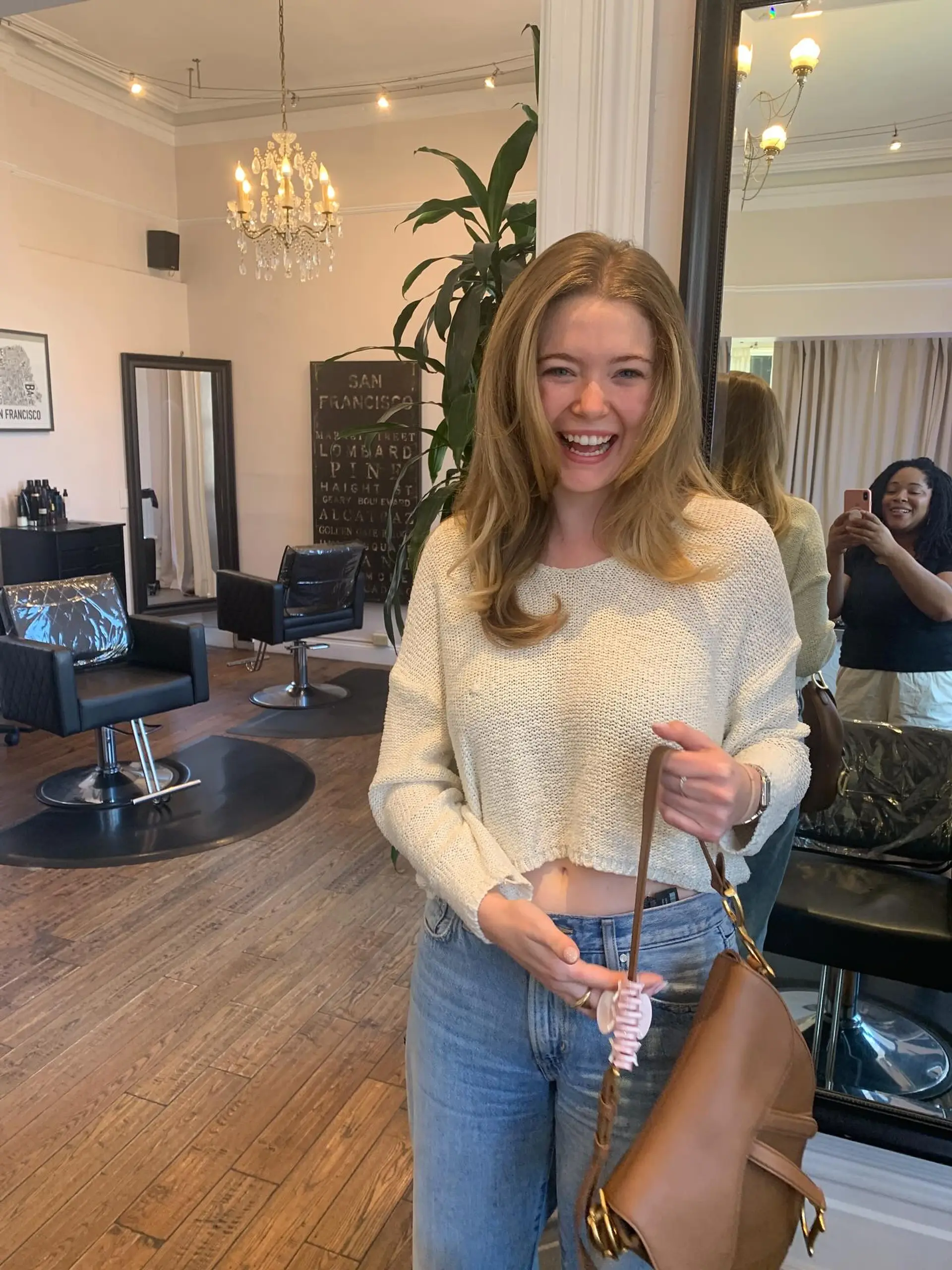 Bouncy, warm golden blonde hair styled into a voluminous blowout with soft face-framing layers. 1