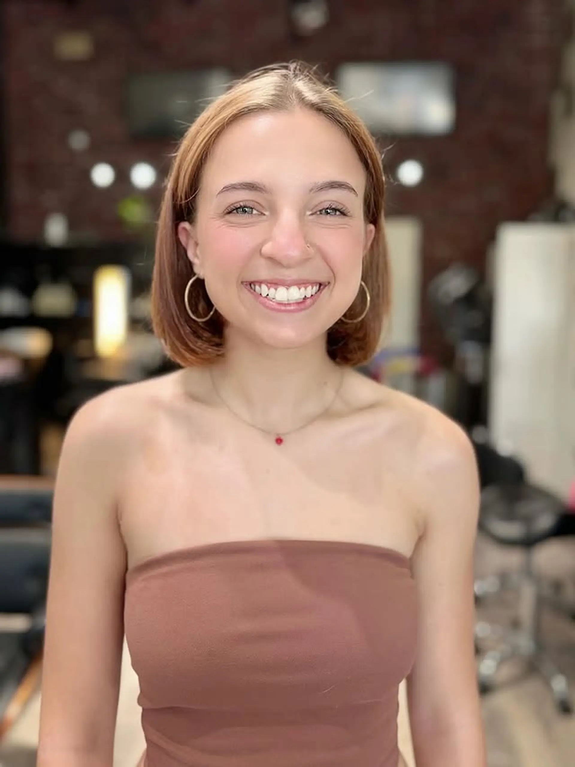 A sharp, chin-length bob with a precise cut, featuring a clean middle part and a smooth, straight finish. 1