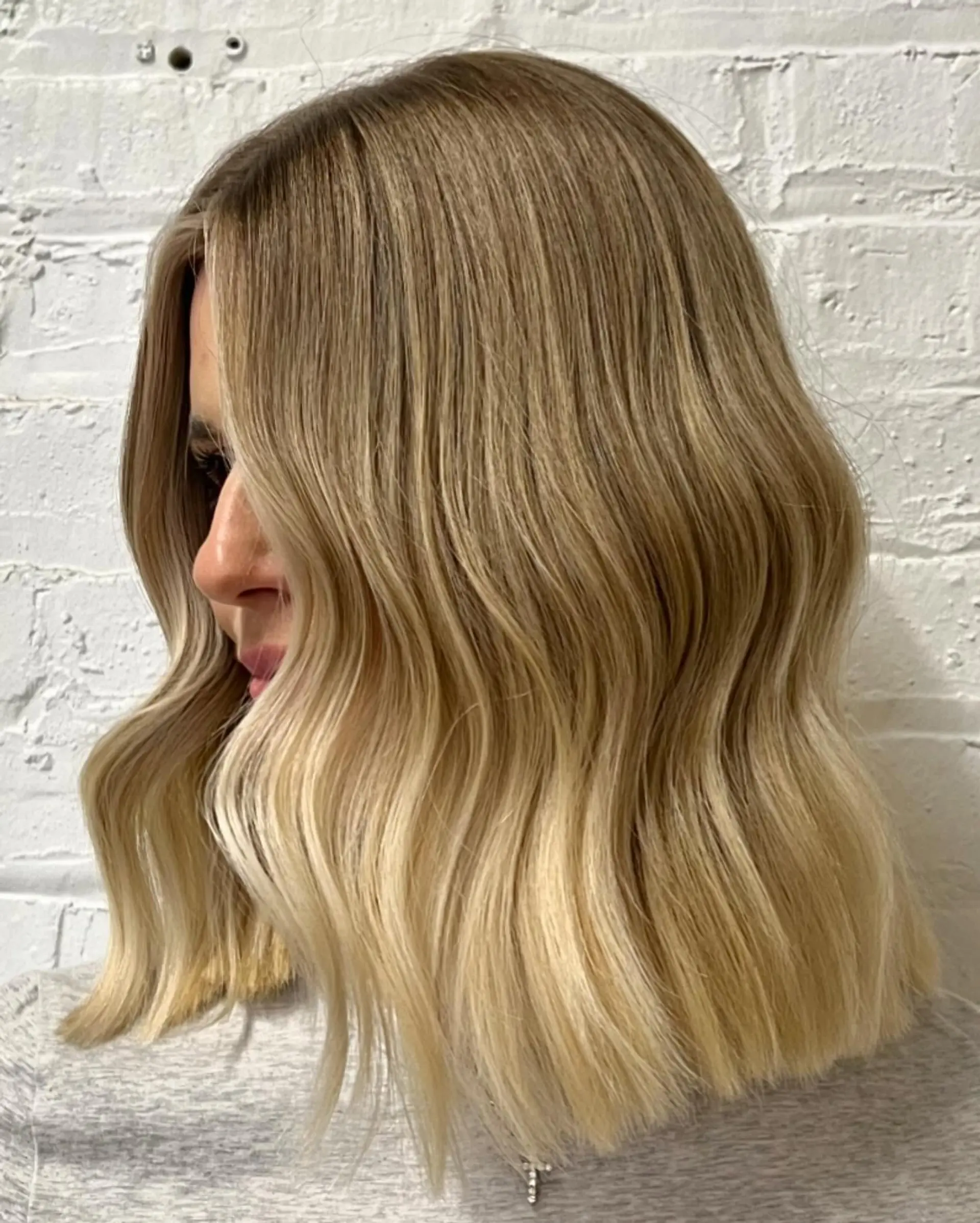 A medium-length lob with soft waves and a blunt cut for a chic and effortless look. 1