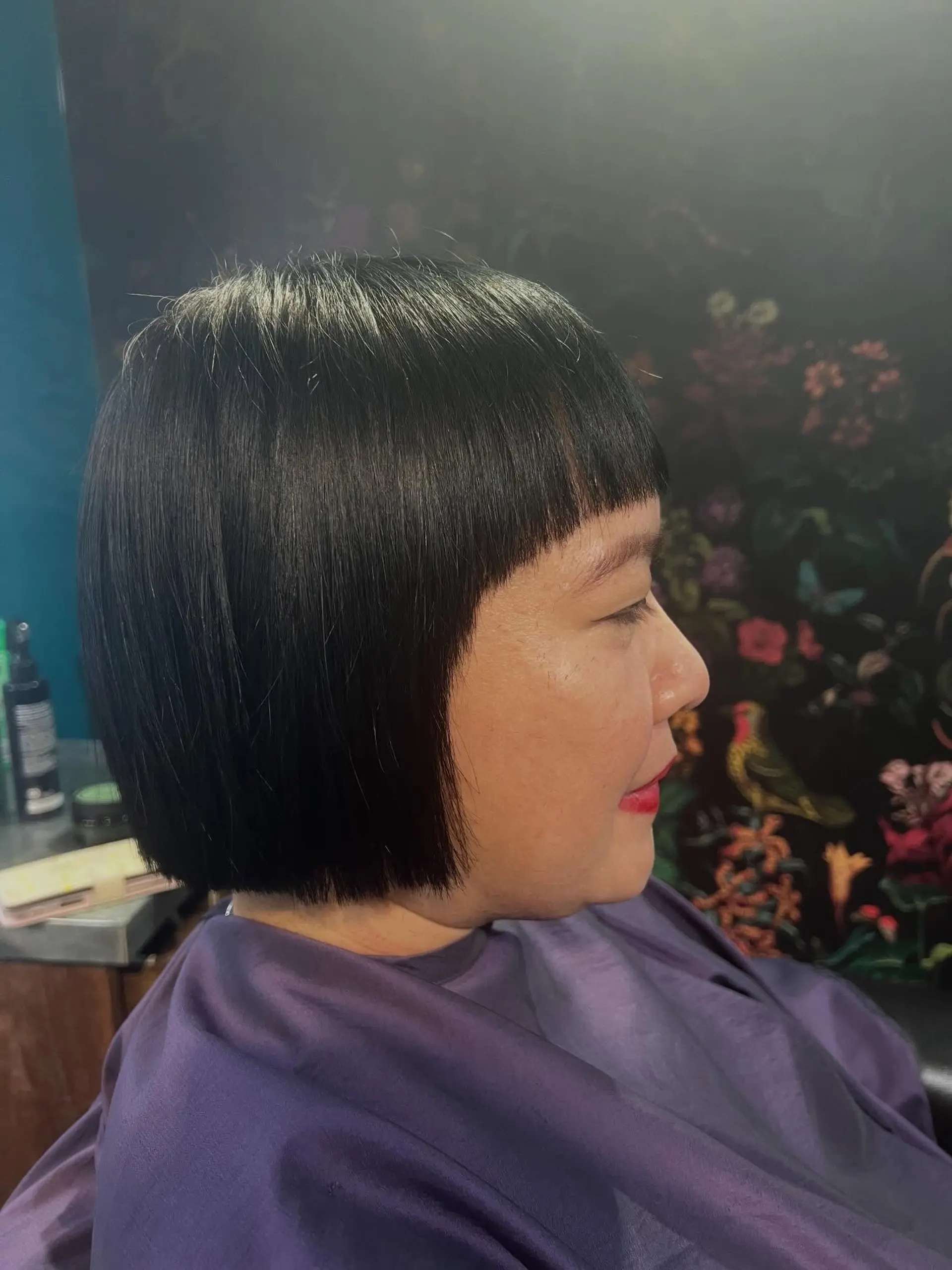 A sleek, chin-length blunt bob cut paired with sharp, straight micro bangs. 1