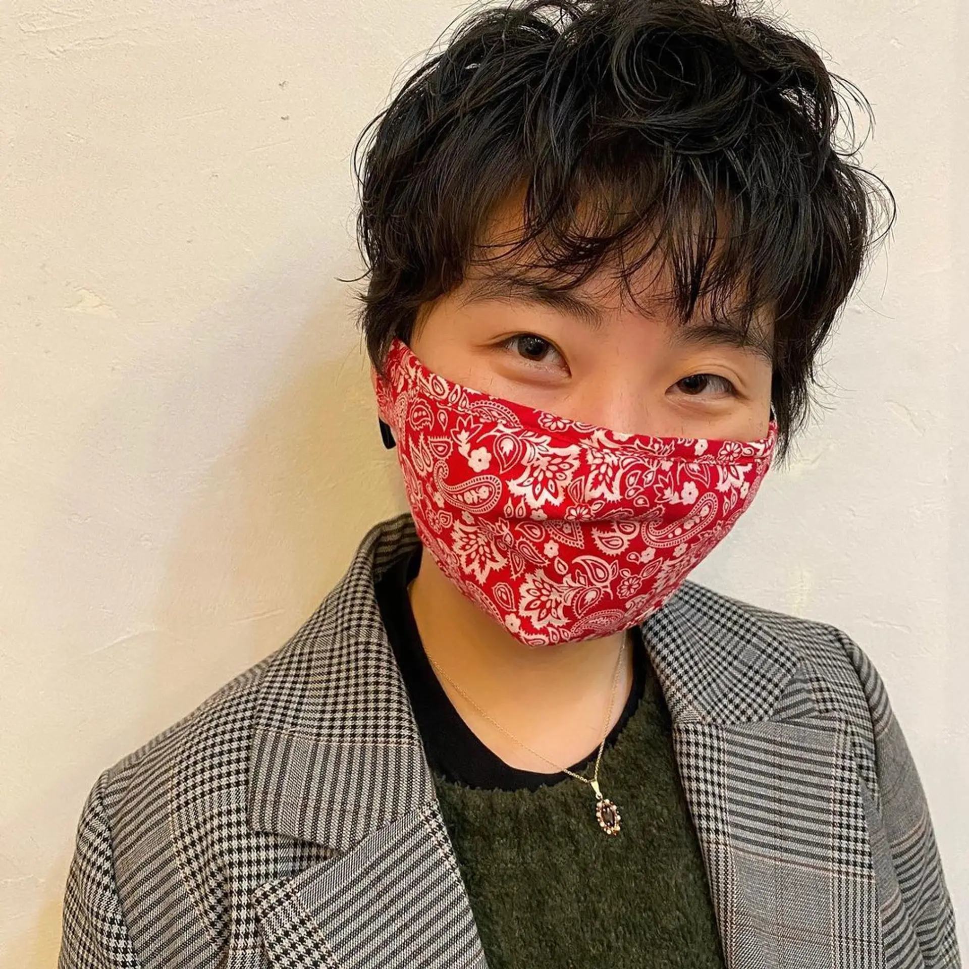 A textured pixie cut with short, wavy layers. The hairstyle features longer top layers left tousled for a casual and effortless look. 1