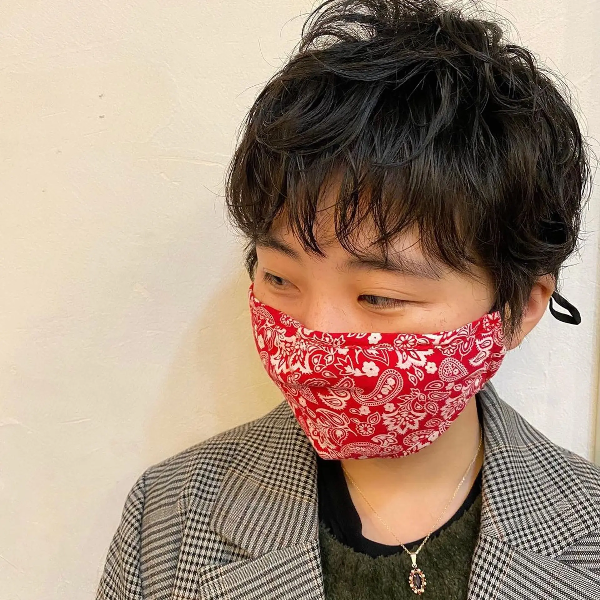 A textured pixie cut with short, wavy layers. The hairstyle features longer top layers left tousled for a casual and effortless look. 2