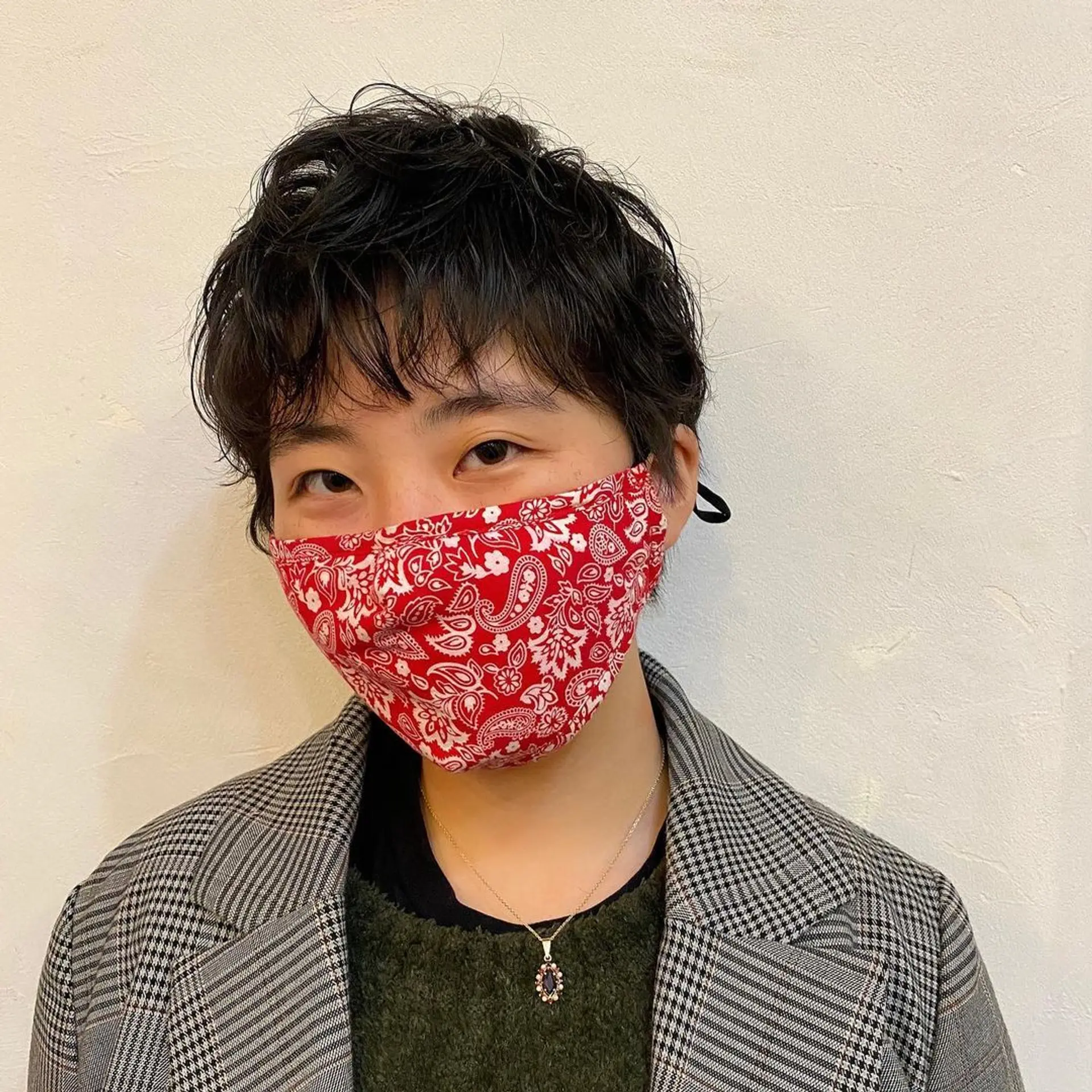 A textured pixie cut with short, wavy layers. The hairstyle features longer top layers left tousled for a casual and effortless look. 3