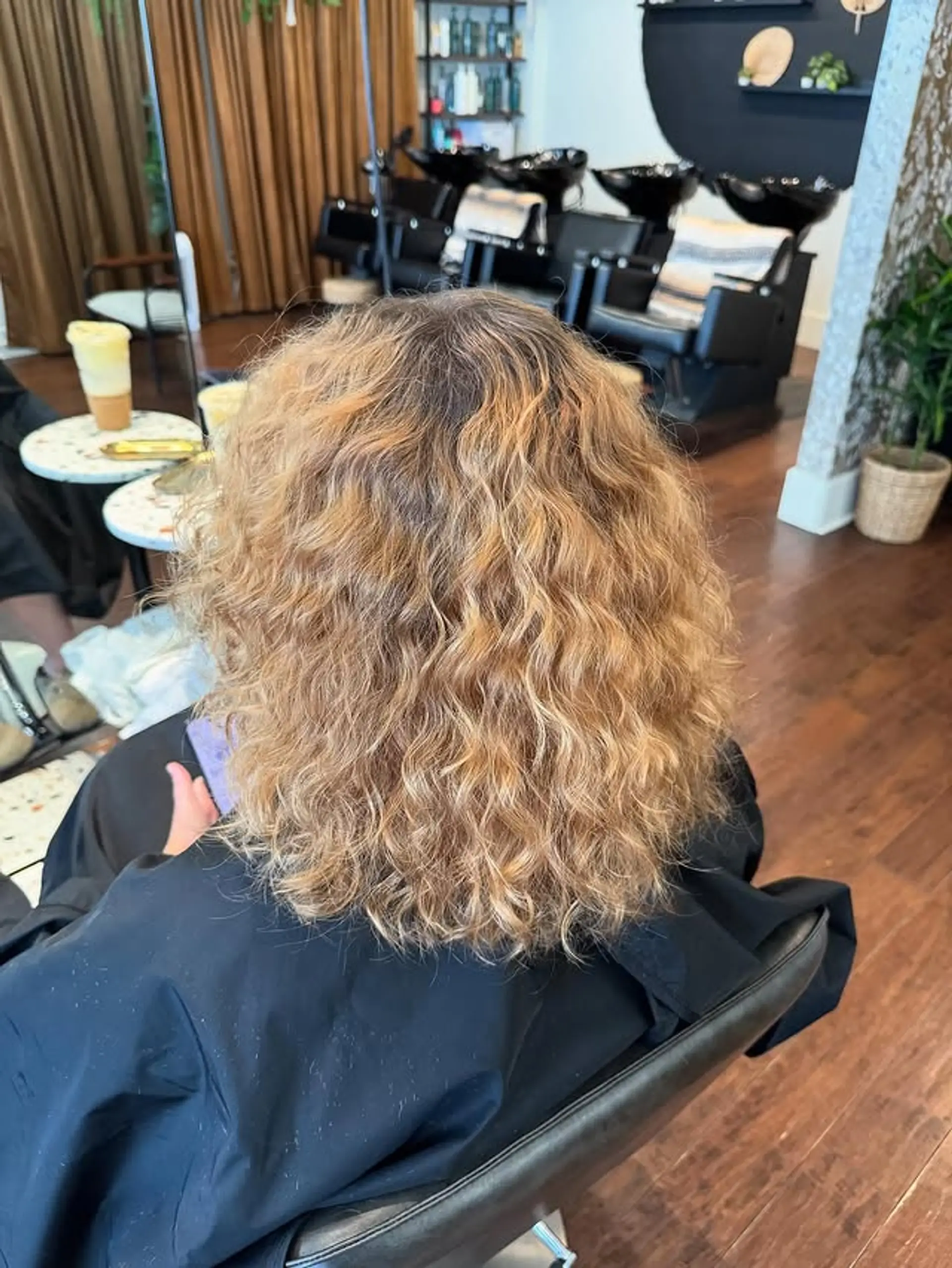 A curly lob with a natural blonde balayage. 1