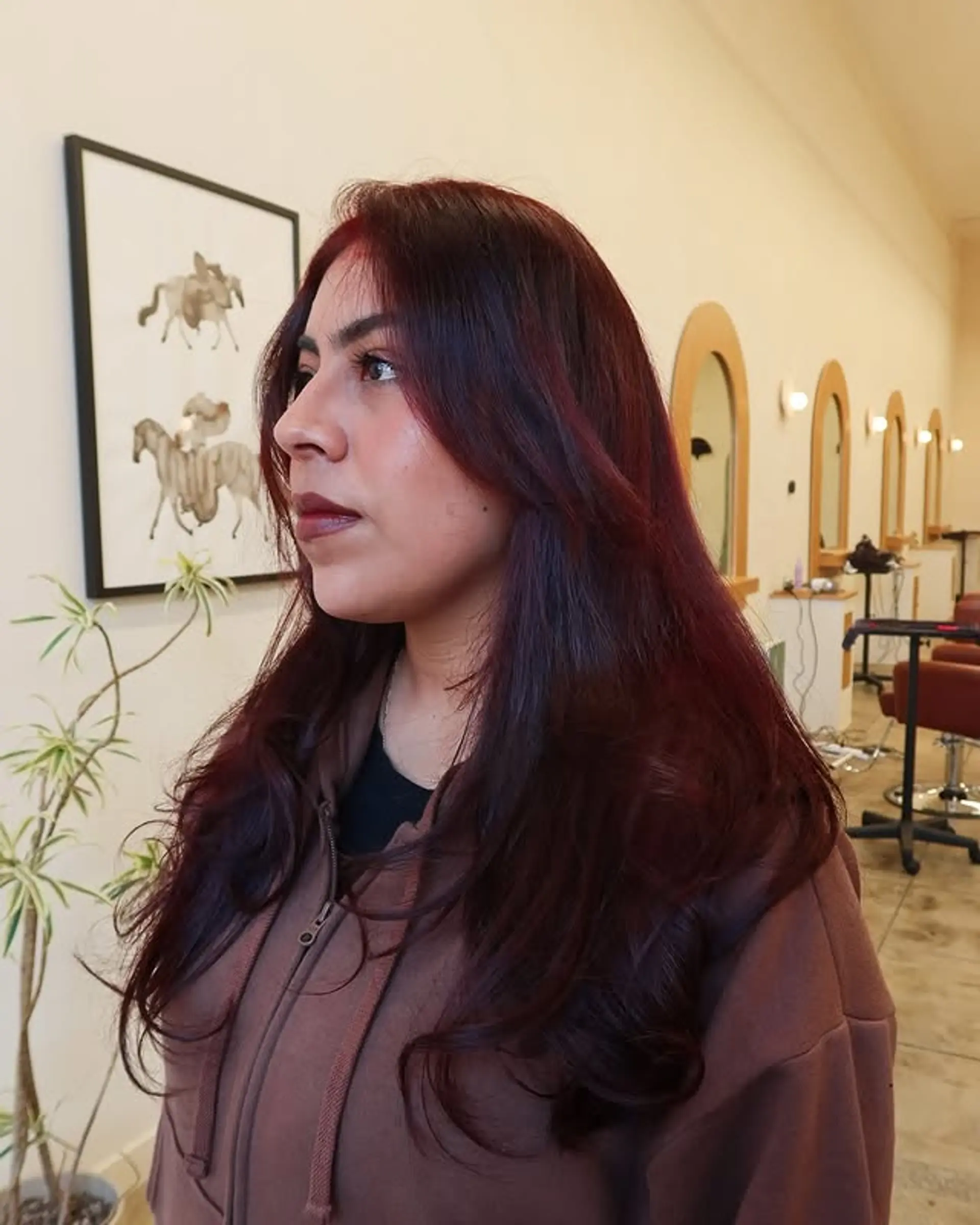 Long layered haircut with soft waves and burgundy color. 1