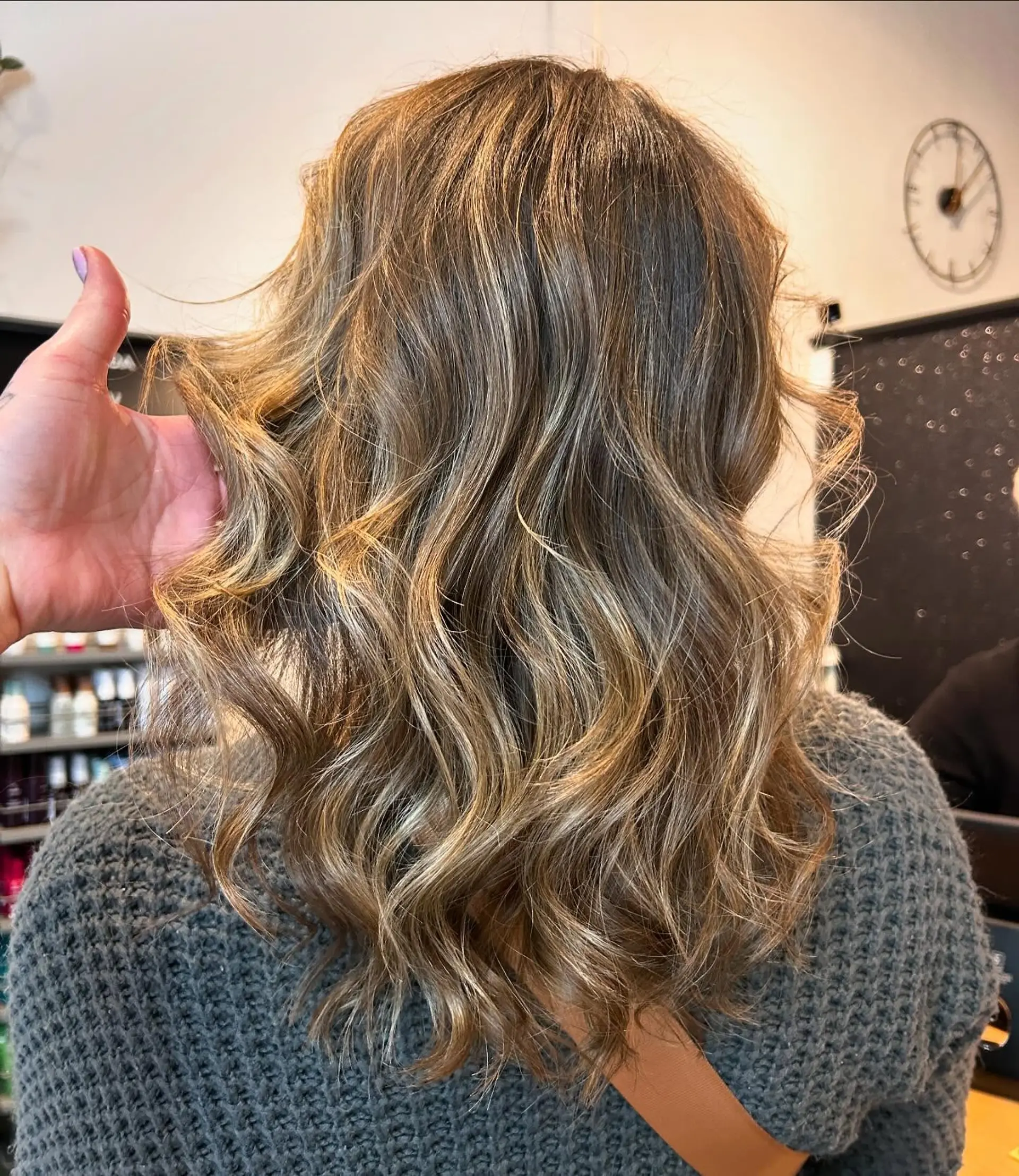 Medium-length dimensional bronde hair styled with loose textured waves. 1