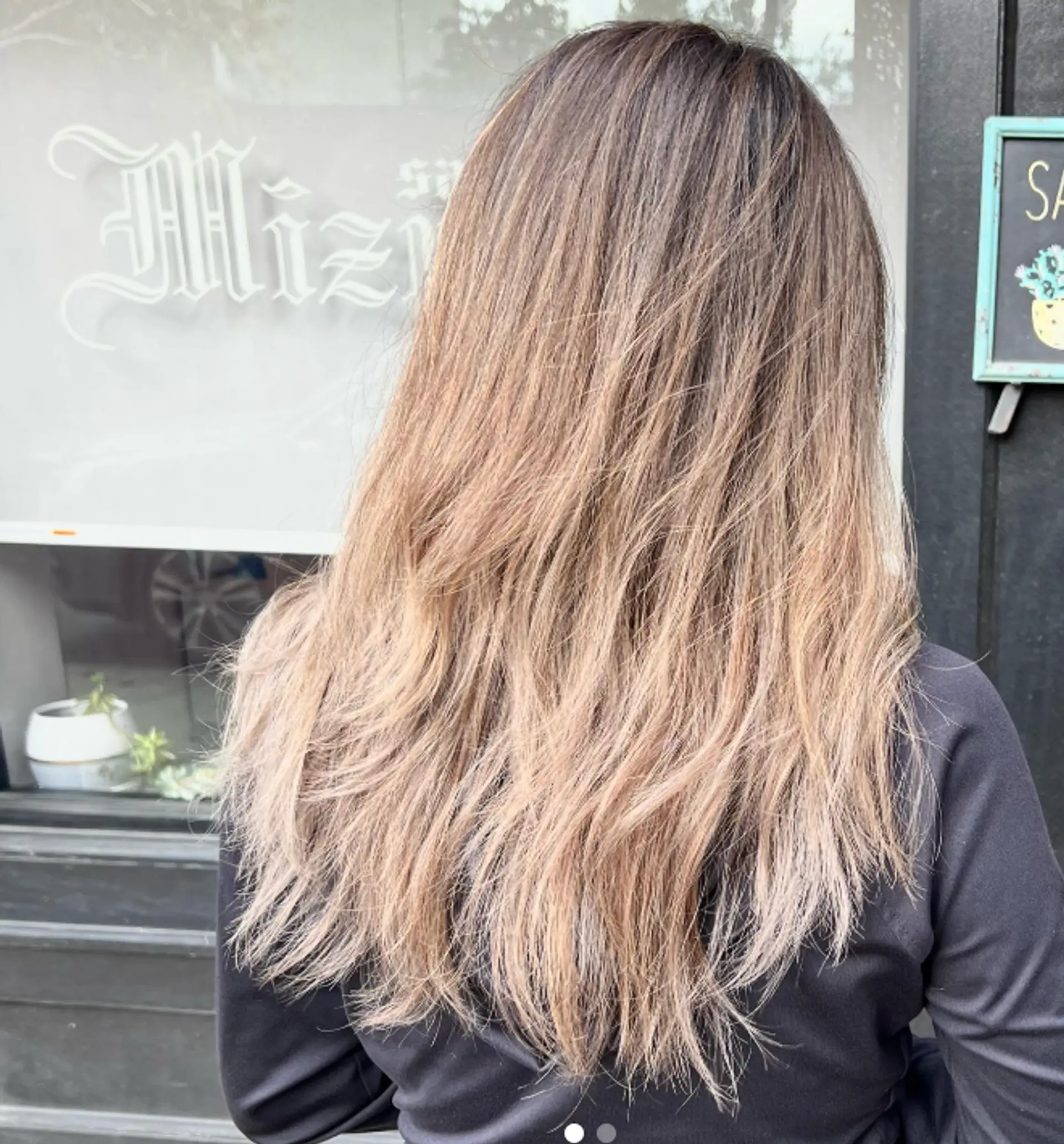 Long layered hair with face-framing layers and bronde coloring. 1